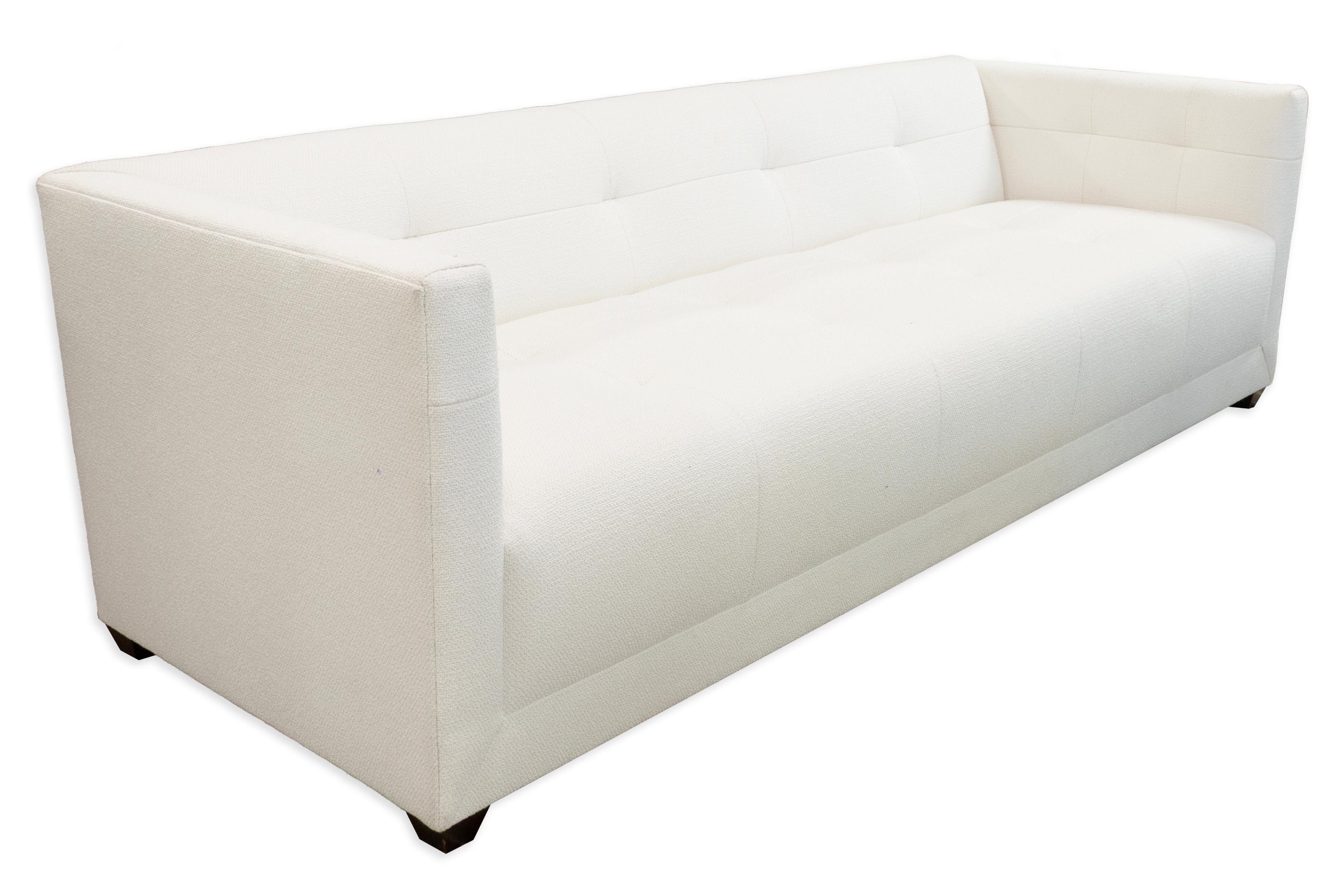 From the Thomas Pheasant Collection for Baker, this contemporary Paris sofa presents a refined blend of clean lines and tailored comfort. Upholstered in crisp white fabric, the design features a streamlined silhouette with squared arms, a tight back