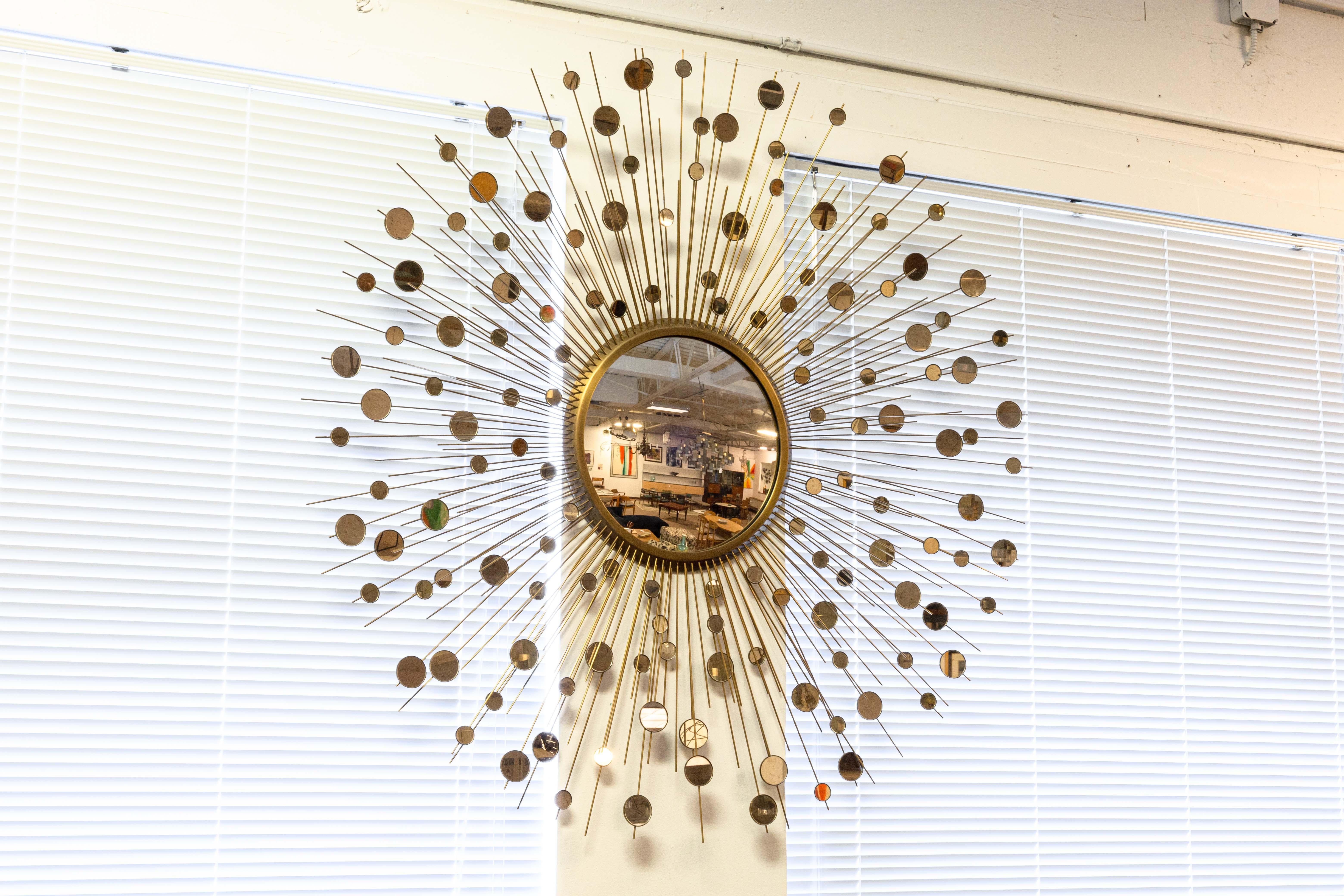 A Thomas Pheasant for Baker constellation mirror. This is an absolutely stunning mirror with a gorgeous mid century modern styling. This piece features a large center convex mirror, with dozens of antennas shooting out from the center with a series
