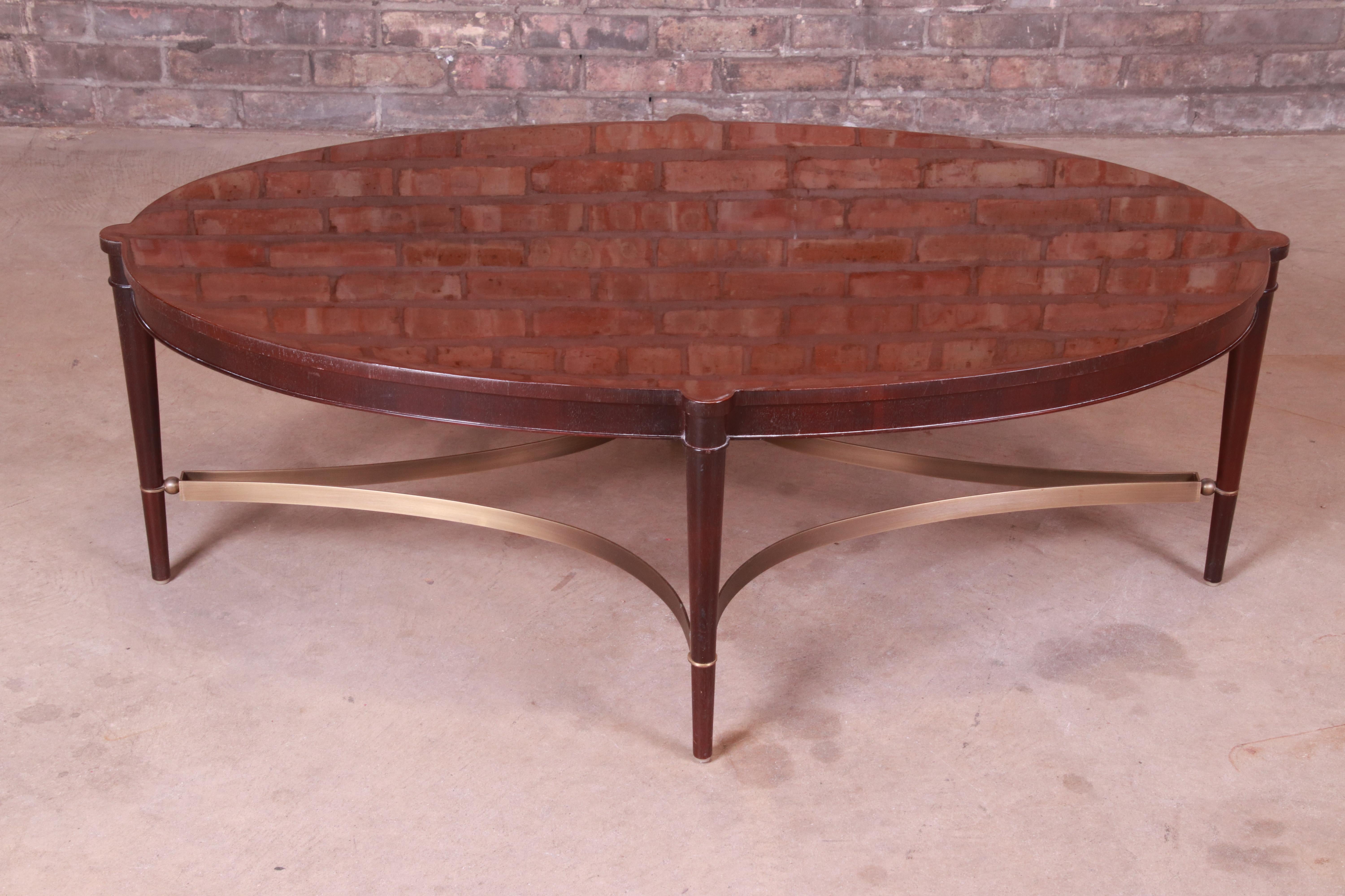 A gorgeous contemporary oval coffee or cocktail table

By Baker Furniture

USA, early 21st century

Mahogany, with brass stretchers.

Measures: 48.5