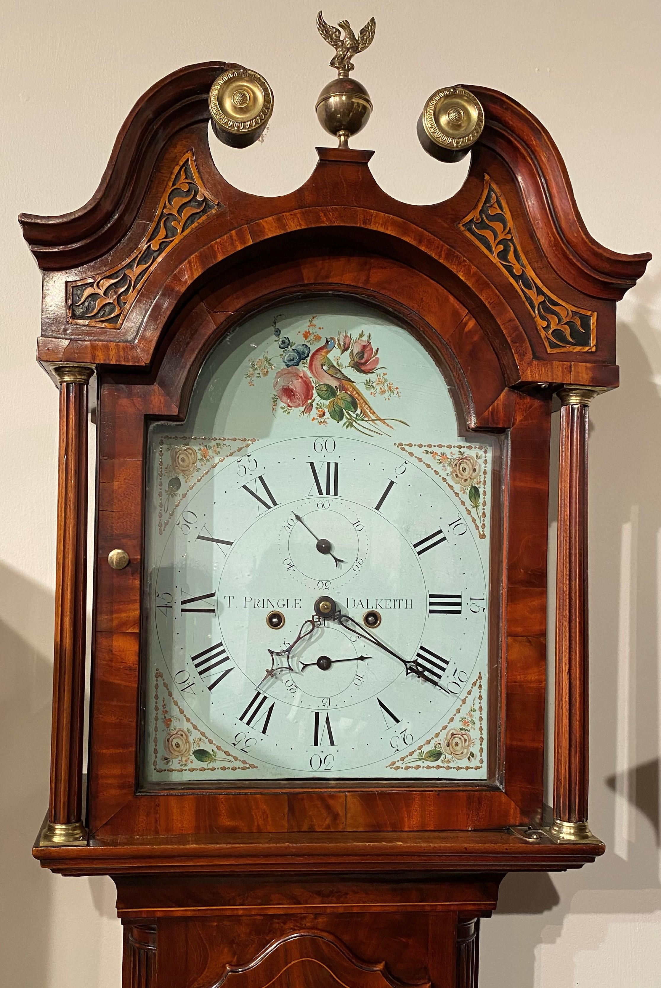 A fine example of an 8-day tall clock in mahogany case made by Thomas Pringle, Scottish clockmaker, active 1830-1836. This beautiful tall case clock features a swan’s neck split pediment with foliate carved decoration, gilt foliate rosettes, and a