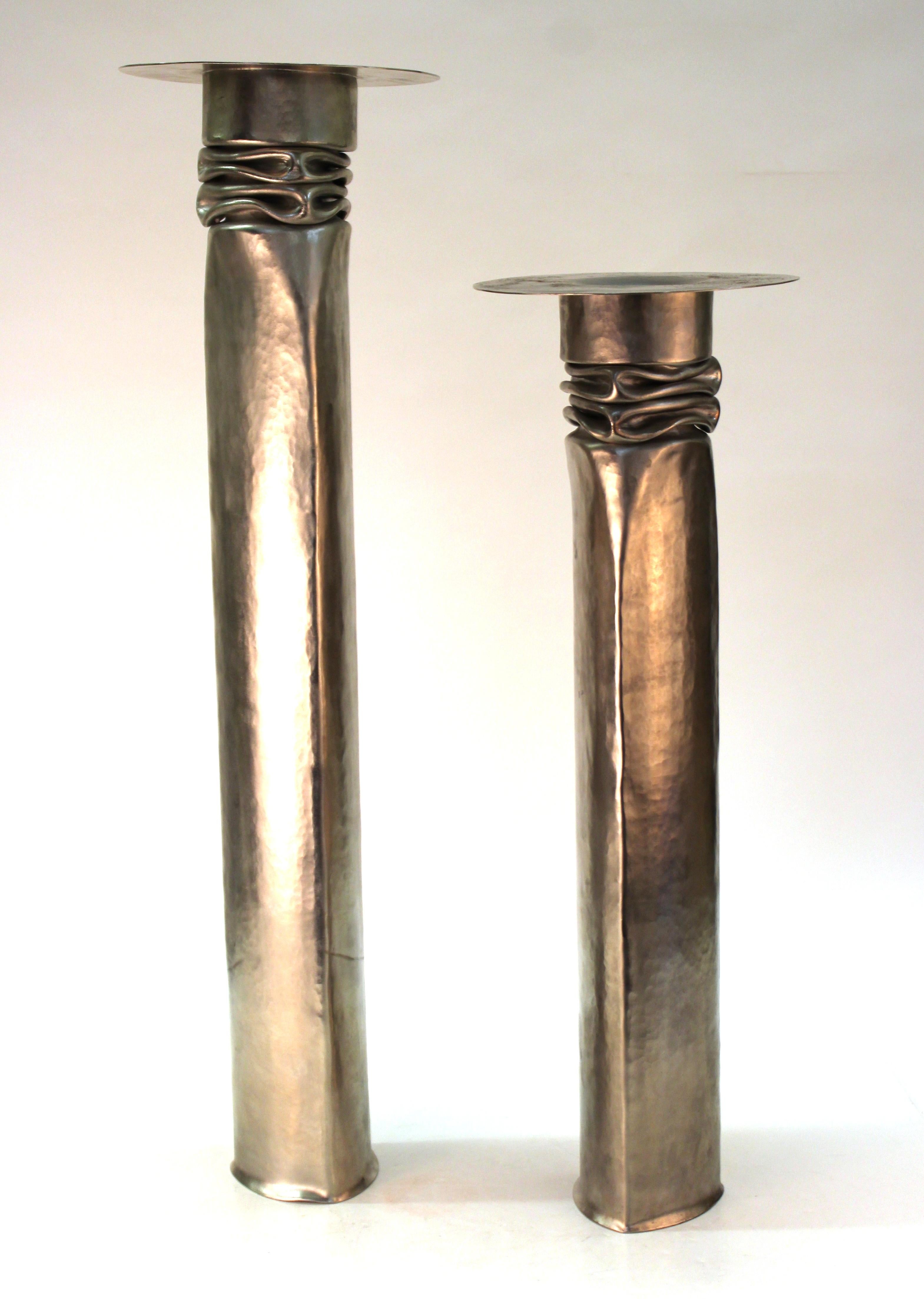 American Modernist pair of handcrafted metal candleholders in nickeled copper, created by famed metal-smith Thomas Roy Markusen in the late 1970s in the United States. The pair has makers marks on the bottom and is in remarkable vintage condition.