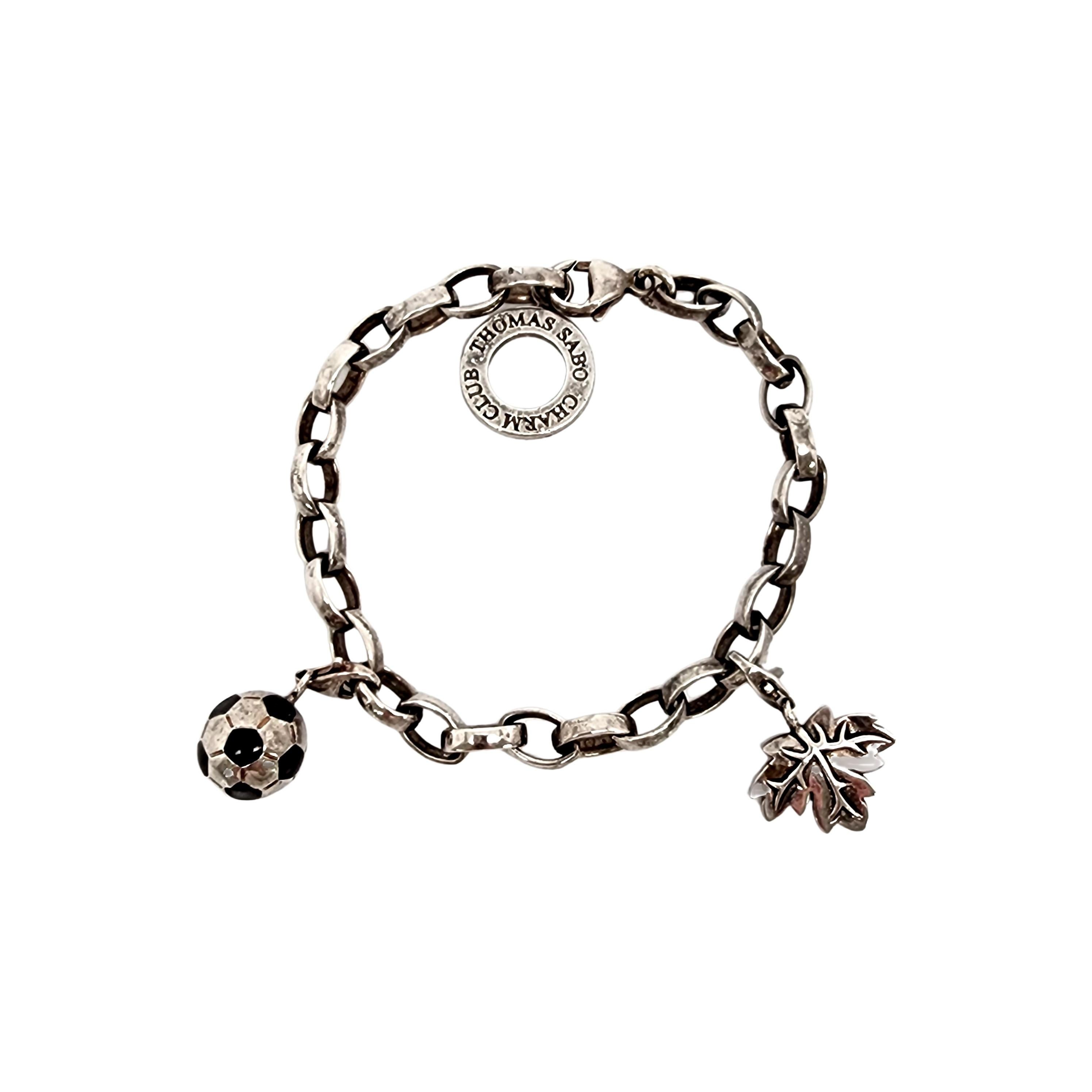 Thomas Sabo Charm Club sterling silver charm bracelet with two charms.

Elongated oval link charm bracelet featuring a soccer ball charm and a leaf charm. Lobster claw closure.

Measures approx 6 1/2