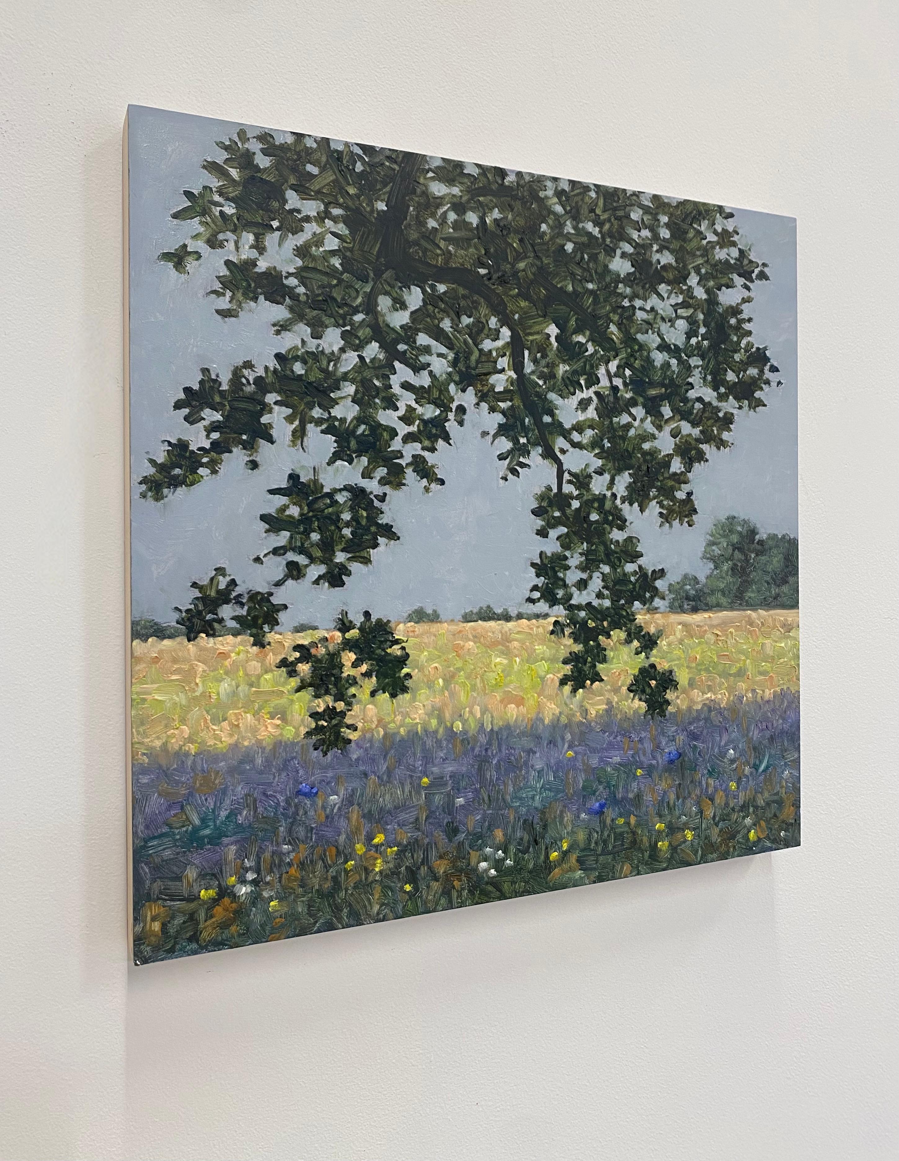 A peaceful outdoor scene in summer of delicately painted violet blue flowers in a green grassy field beneath a tree with dark green leaves, beautifully capturing the idyllic feel of a field of wildflowers in early July. Signed, dated and titled on