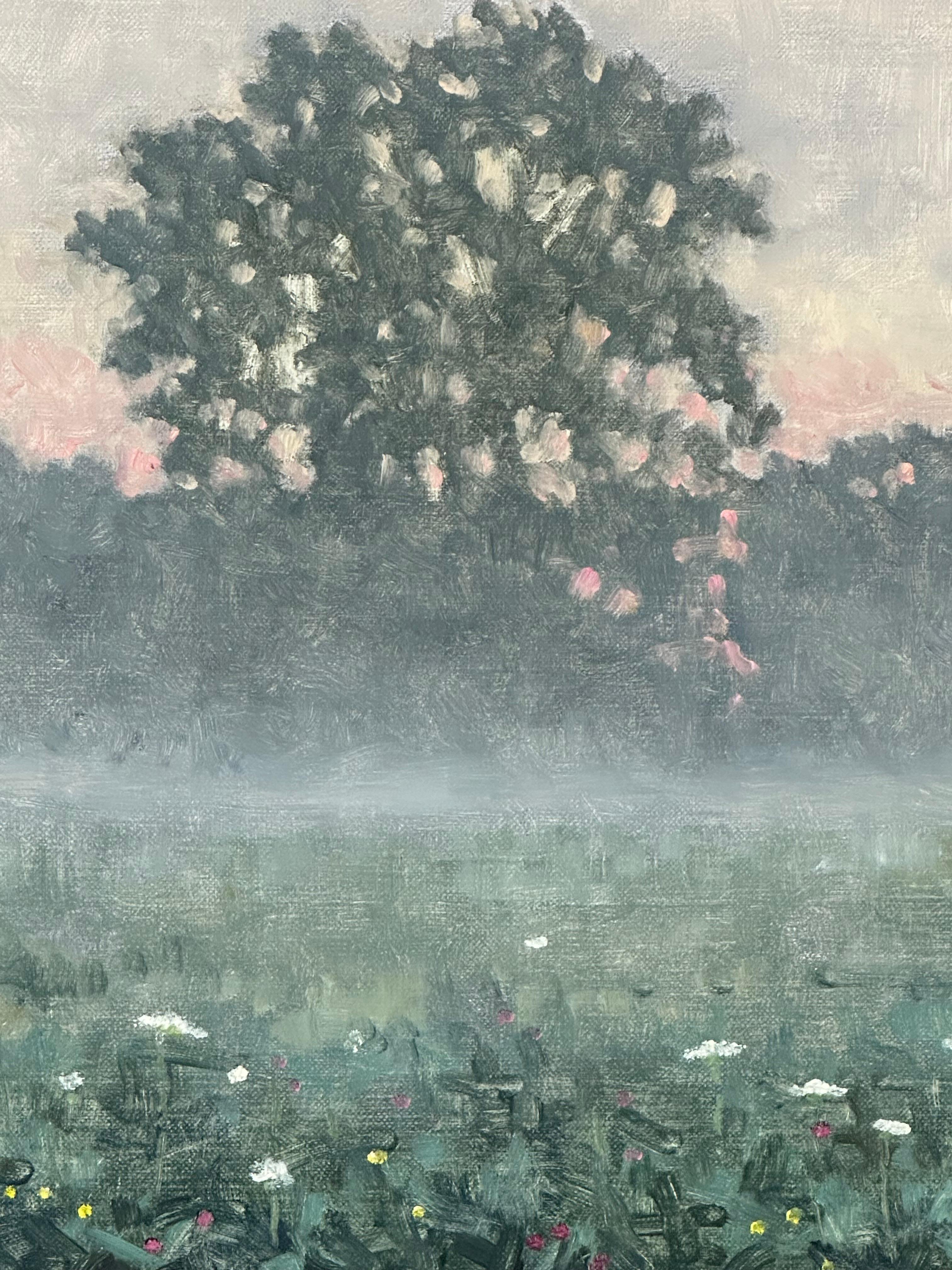 Cette peinture de paysage contemporaine à l'huile sur panneau présente une scène estivale paisible, capturant magnifiquement l'atmosphère idyllique d'un champ de fleurs sauvages et d'arbres enveloppés de brouillard à la mi-juillet. Signé, daté et