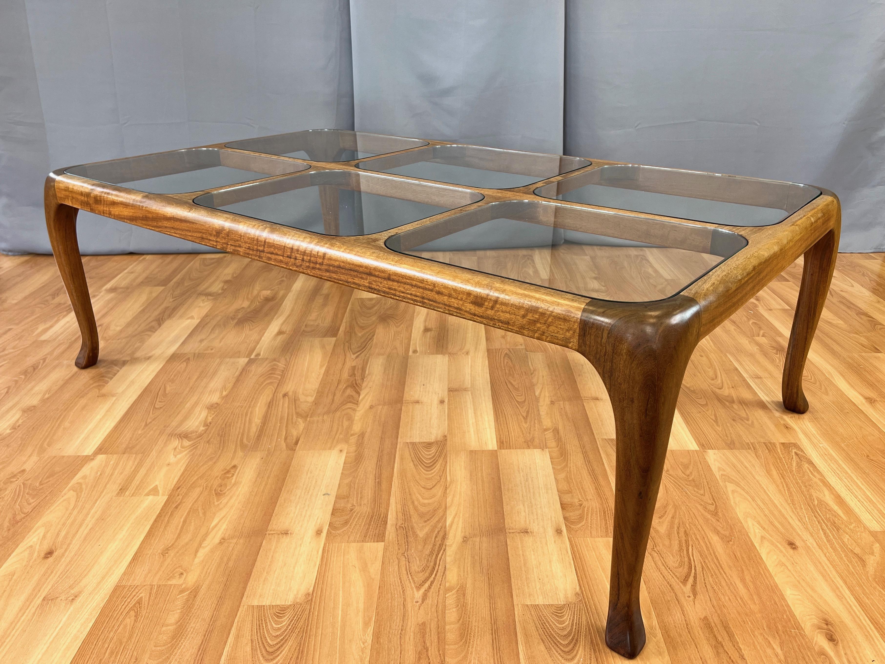 A large and very handsome 1982 walnut coffee with inset glass multi-pane top by Ashland, Oregon artist, woodworker, and furniture designer Thomas Saydah. 

Hand-sculpted solid walnut frame with gorgeous grain and graceful cabriole legs. Window-like