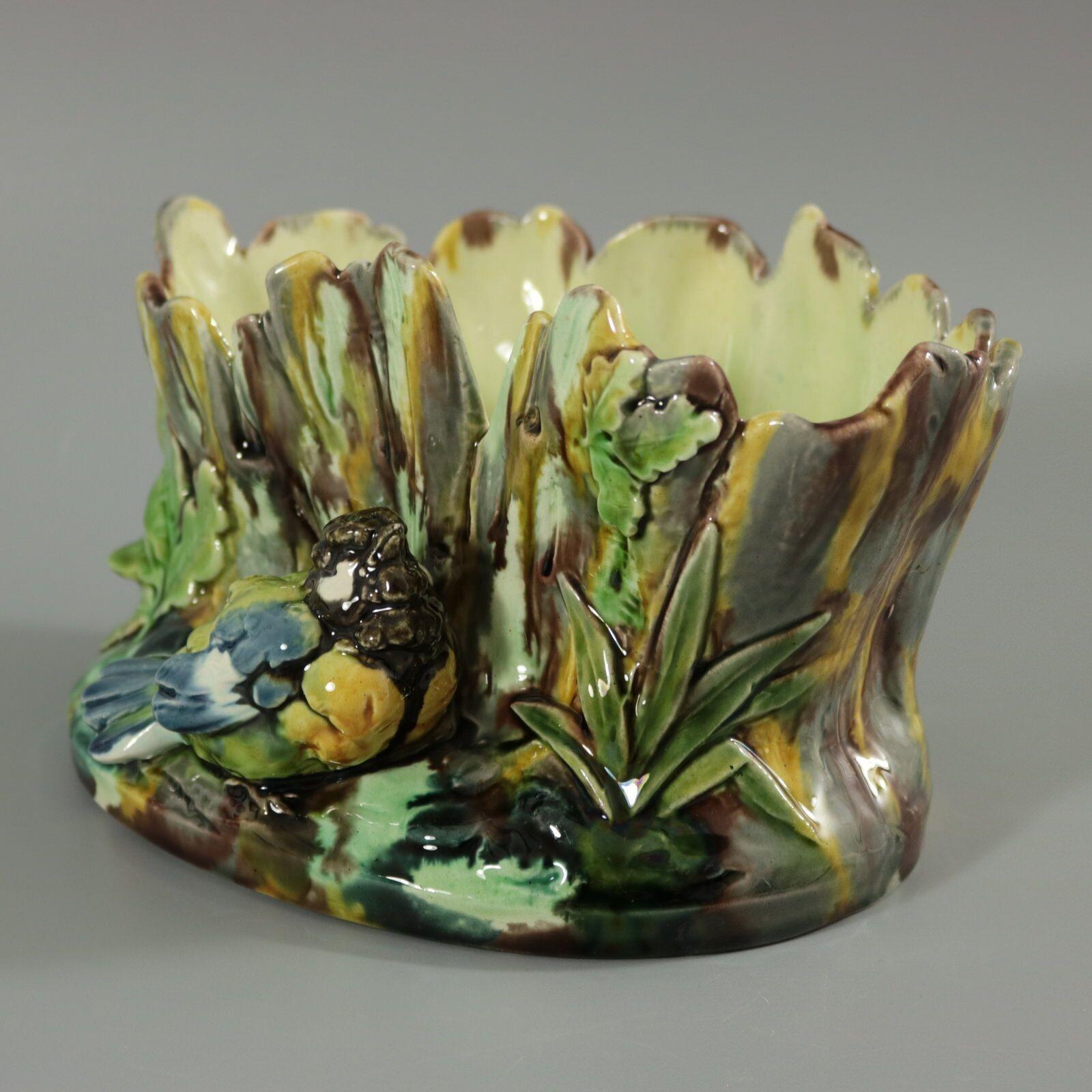 Thomas Sergent French Majolica flower pot which features a great tit (bird) sat in front of a tree stump. Oak leaves either side. Colouration: green, blue, yellow, are predominant. The piece bears maker's marks for the Thomas Sergent pottery.