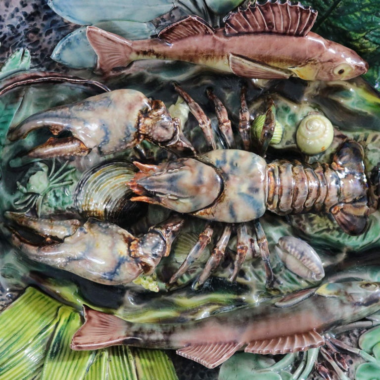Thomas Sergent Majolica wall platter which features highly detailed models of a crayfish, shellfish, fish, an eel, a frog, a crab, a lizard and a variety of leaves. Colouration: green, blue, brown, are predominant. The piece bears maker's marks for