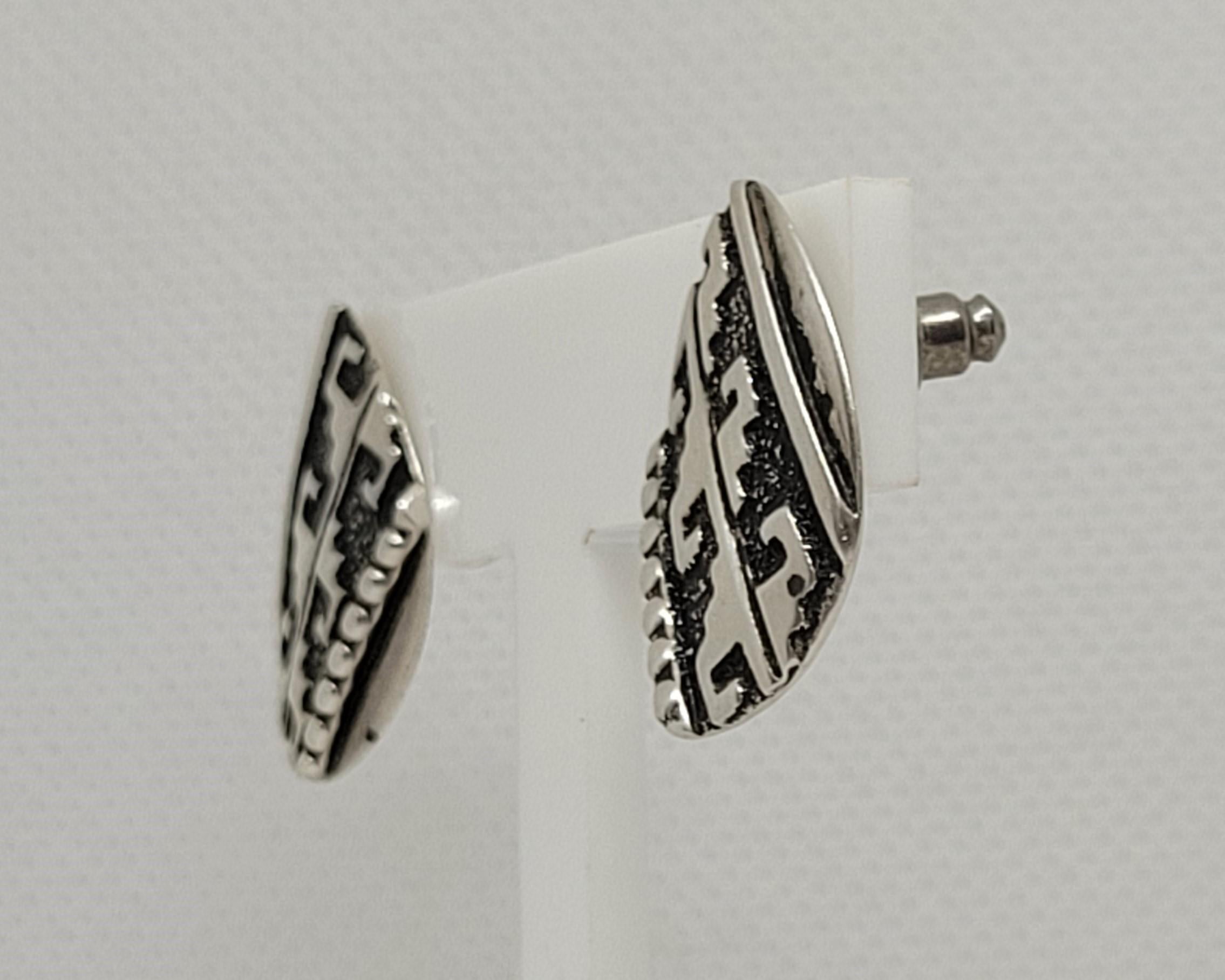 Beautiful Navajo American Indian silver earrings designed by the world-famous silversmith, Thomas Singer. Singer, a traditional Navajo silversmith, learned his craft from his father while growing up on a Navajo reservation. These earrings are 5.8