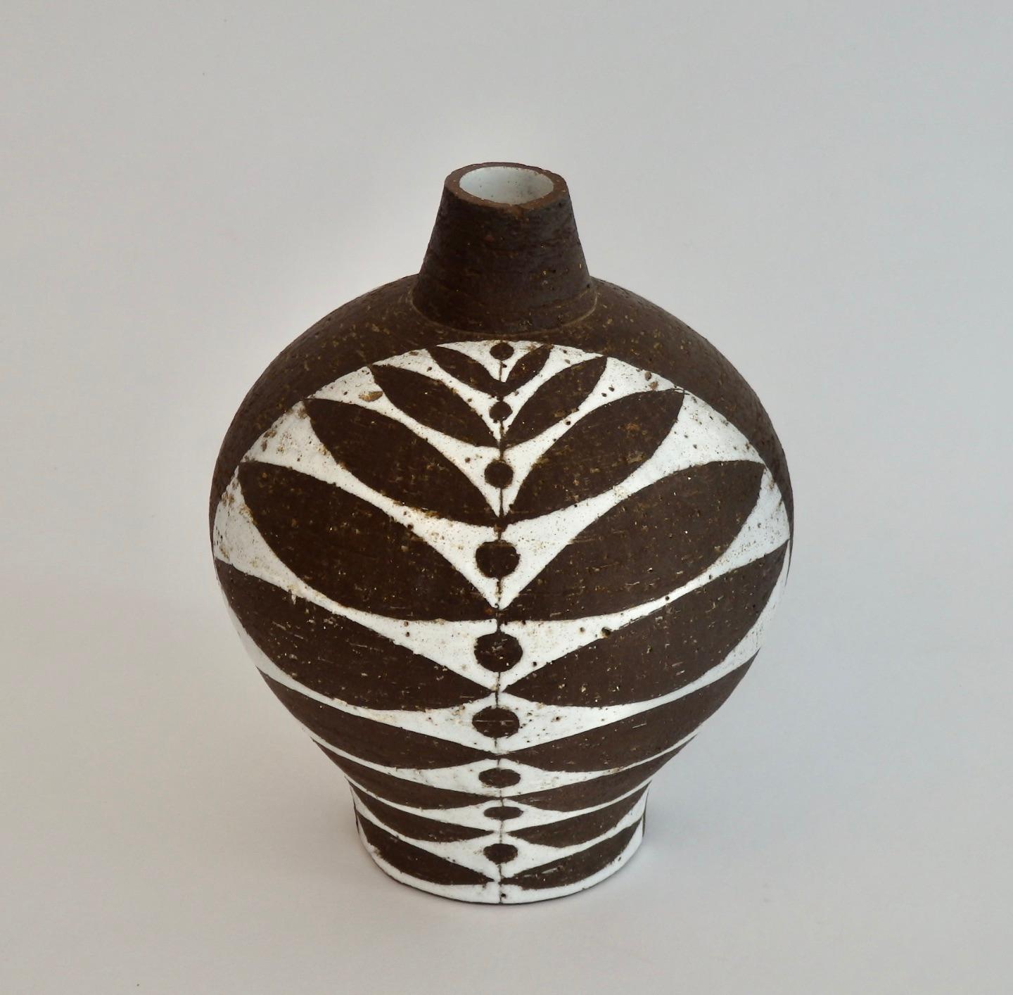 Volcanic dark glaze pottery vessel with white glaze embellishment. Marked TT Denmark.