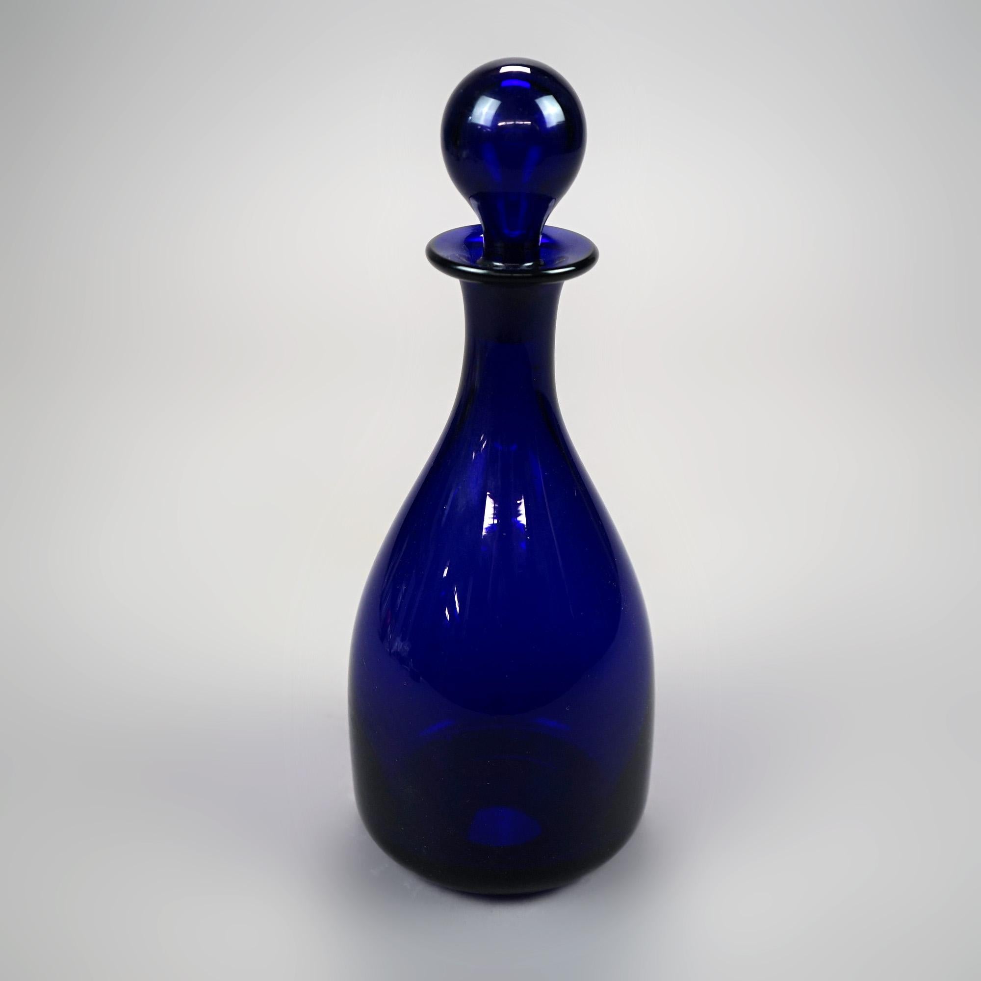 An antique liquor decanter by Thomas Webb offers cobalt blue art glass vessel with stopper, maker signed, c1920

Measures - 10.5''H x 4''W x 4''D.

Catalogue Note: Ask about DISCOUNTED DELIVERY RATES available to most regions within 1,500 miles of