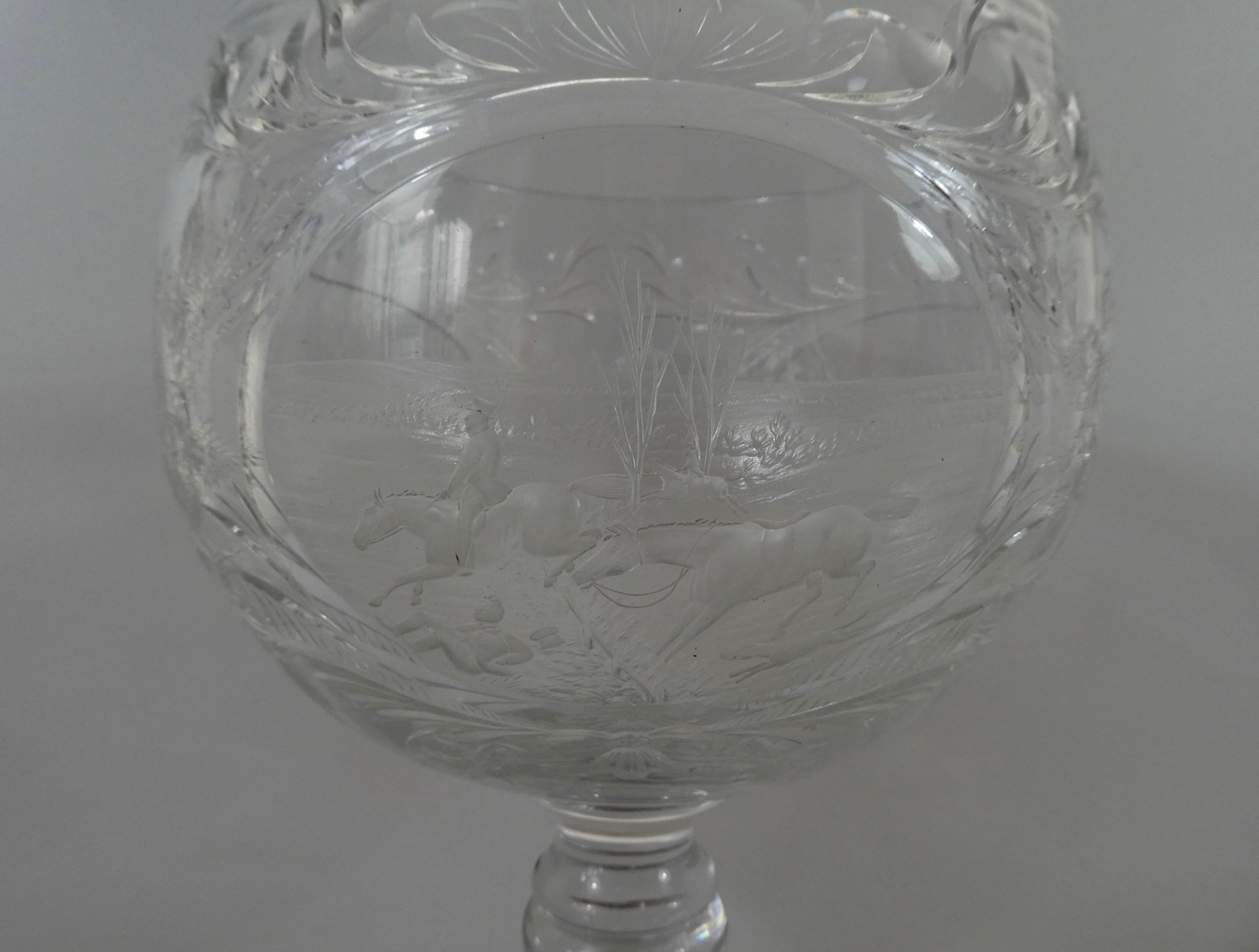 A fine and rare Thomas Webb and Corbett Ltd glass goblet, circa 1930, signed W.G. Webb. Finely engraved with three panels depicting hunting scenes. The first with huntsmen on horses and hounds leaping over a hedge and signed W.G. Webb. The second