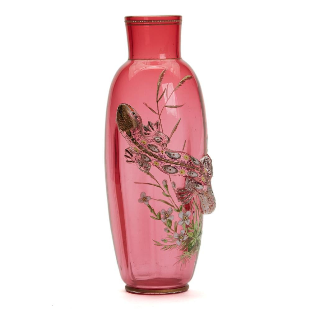 A rare and stunning antique Thomas Webb & Sons cranberry glass vase with ribbed design applied in relief with a lizard with painted enamel and gilded detail and set against an enameled floral and grass design by Jules Barbe. The tall elegantly