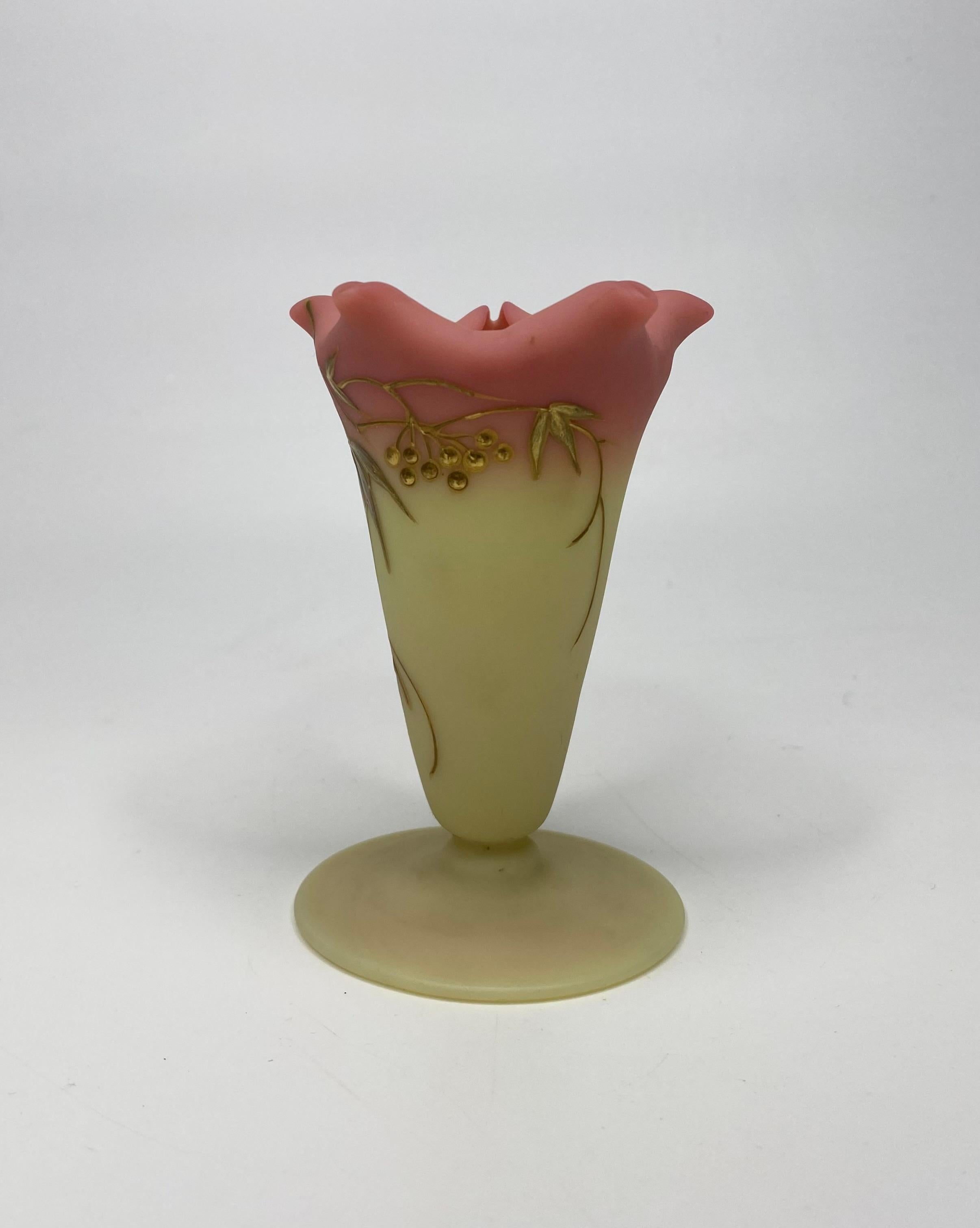 Thomas Webb & Sons, Queens Burmese Ware glass vase, c. 1900. The floral form glass vase, set upon a circular pedestal foot, and gilded with leaves and berries.
Thomas Webb & Sons, Queens Burmese Ware, Patented, circular mark to the foot, and