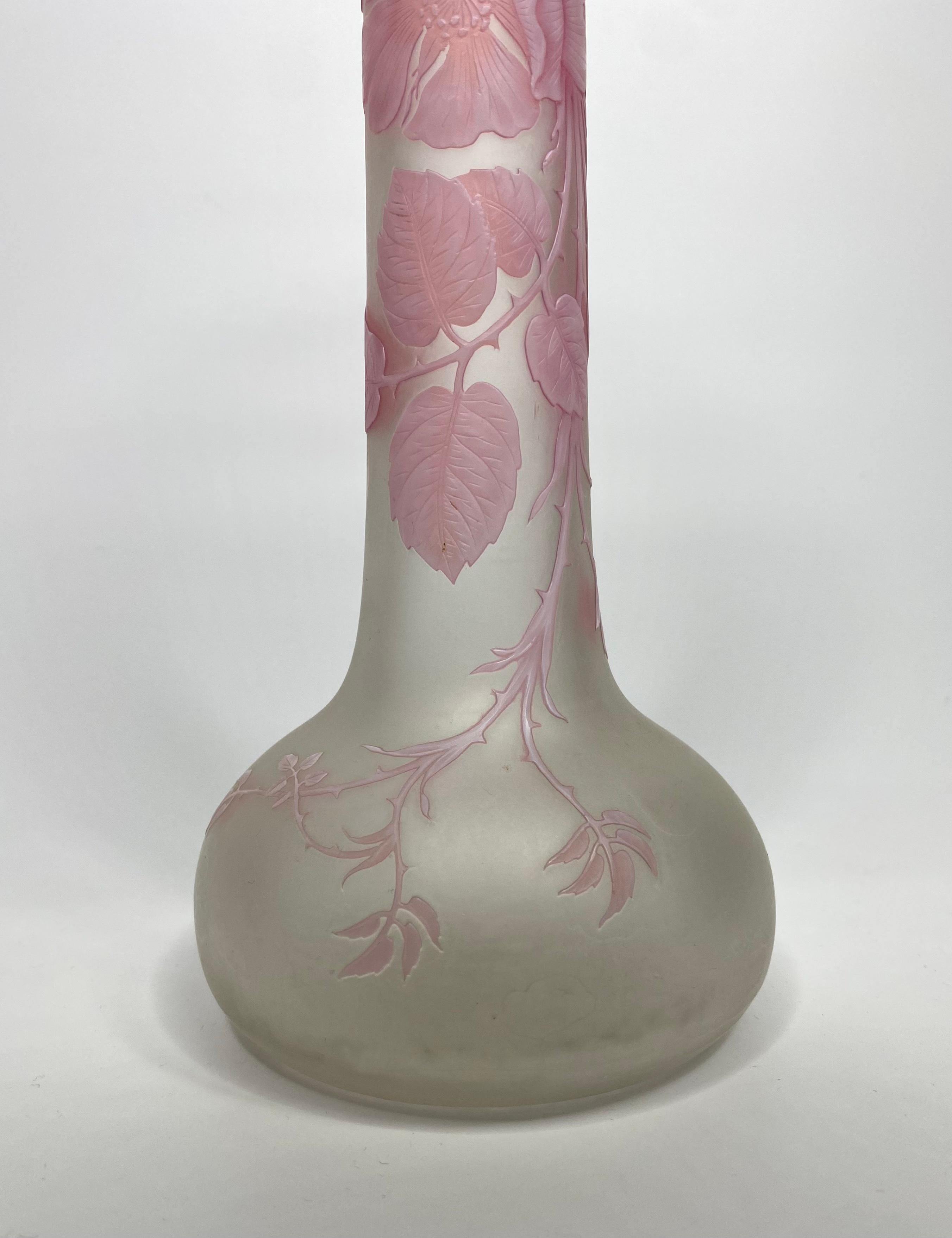 Thomas Webb and Sons large, three colour cameo glass vase, c. 1870. The globular vase, with an elongated neck finely decorated with a flowering Briar rose, in white glass, over pink glass, on an pearlescent glass ground. The details of the flowers,