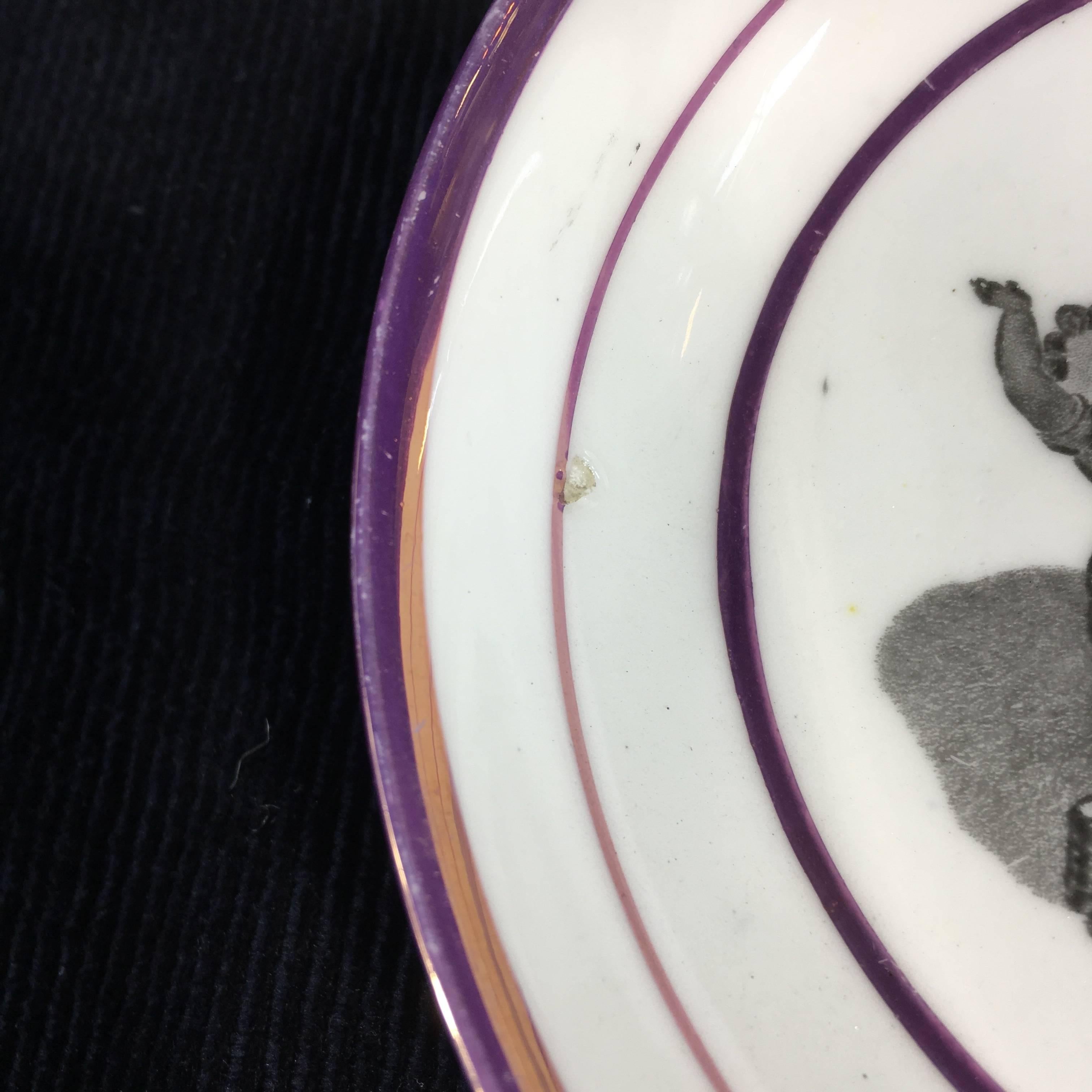 Thomas Wolfe & Co cup and saucer, bat printed with a bucks type print in a purple lustre border,
circa 1810.
