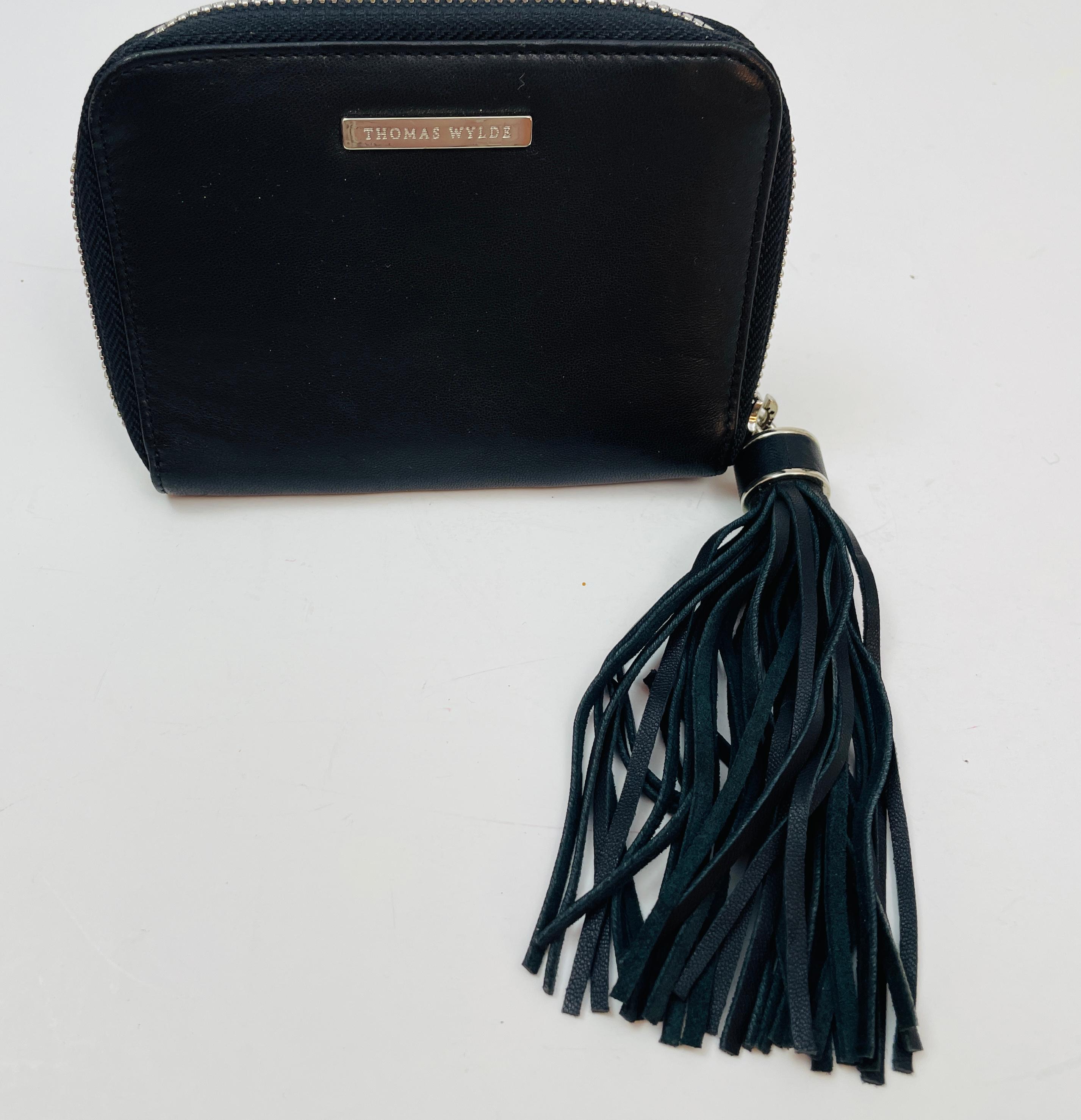 Thomas Wylde Black Leather Wallet Clutch.
Signature tassel zip pull.
Zip around wallet, interior cash slots and interior card holders and smartphone holder.
High quality leather, luxury brand.
Excellent condition, very clean, no flows.
Leather