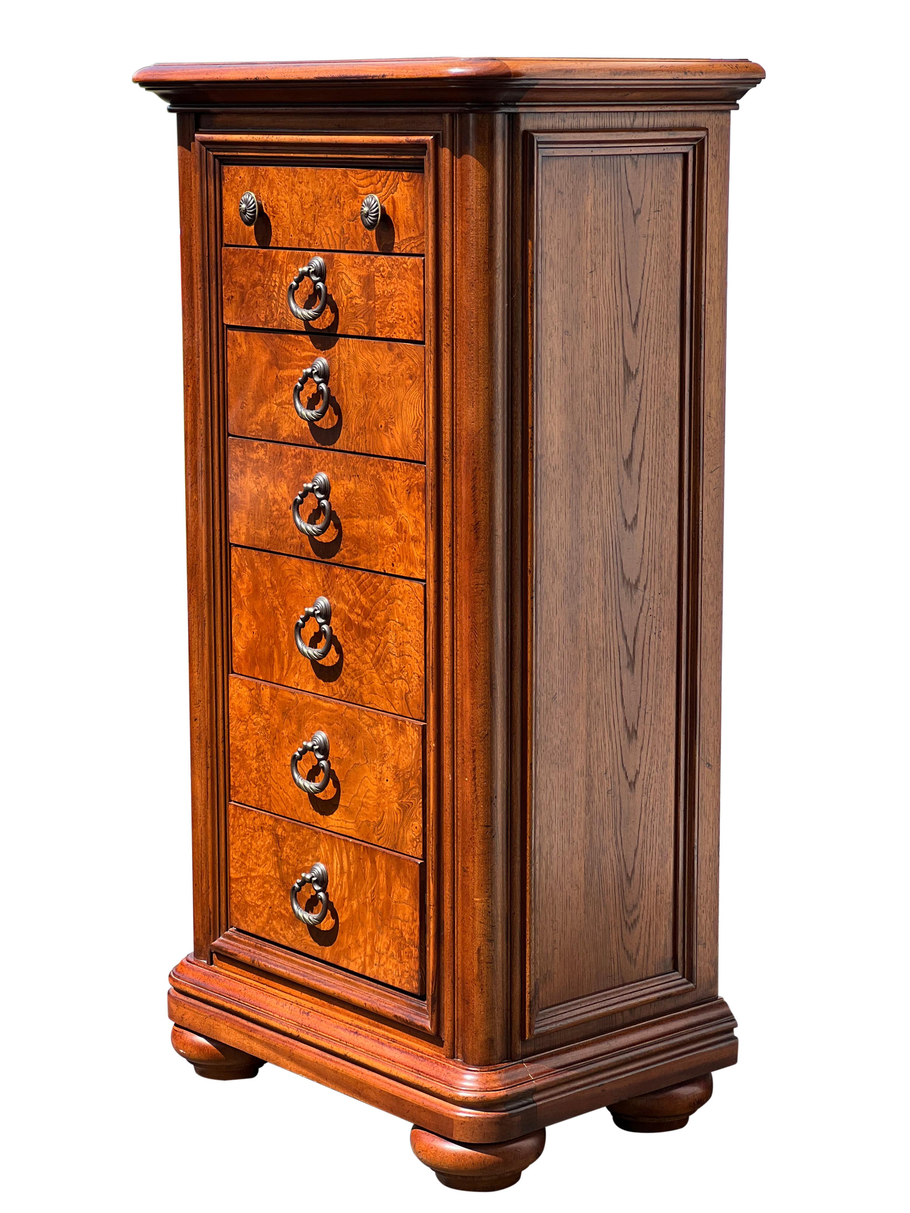Handsome Thomasville lingerie chest from the British Gentry Collection.

Beautiful molding frames the burl wood dovetail drawers which have elegant, mixed metal drop pull handles. The top drawer has round knobs and offers felt lined, divided