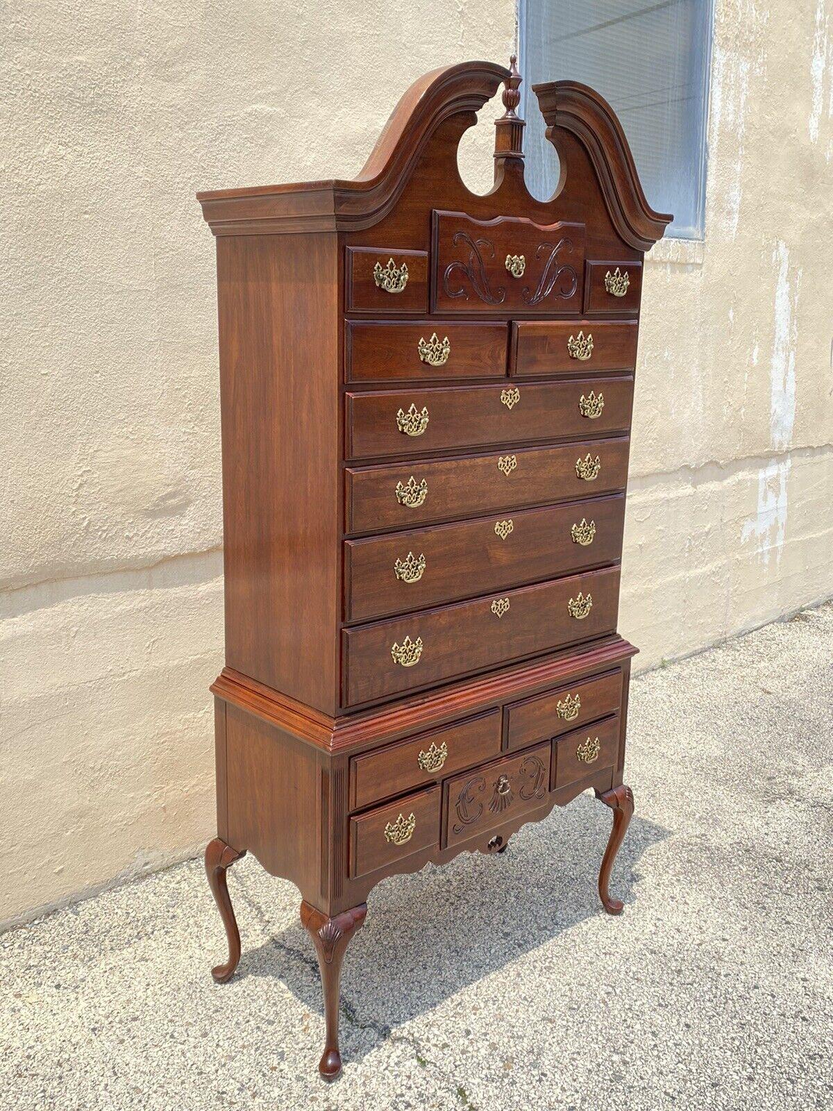 Thomasville Cherry Wood Queen Anne Style Highyboy Tall Chest Dresser. Item features a tall impressive form, Queen Anne style legs, nice carvings, 14 dovetailed drawers, original stamp, quality American craftsmanship. Circa Late 20th Century.
