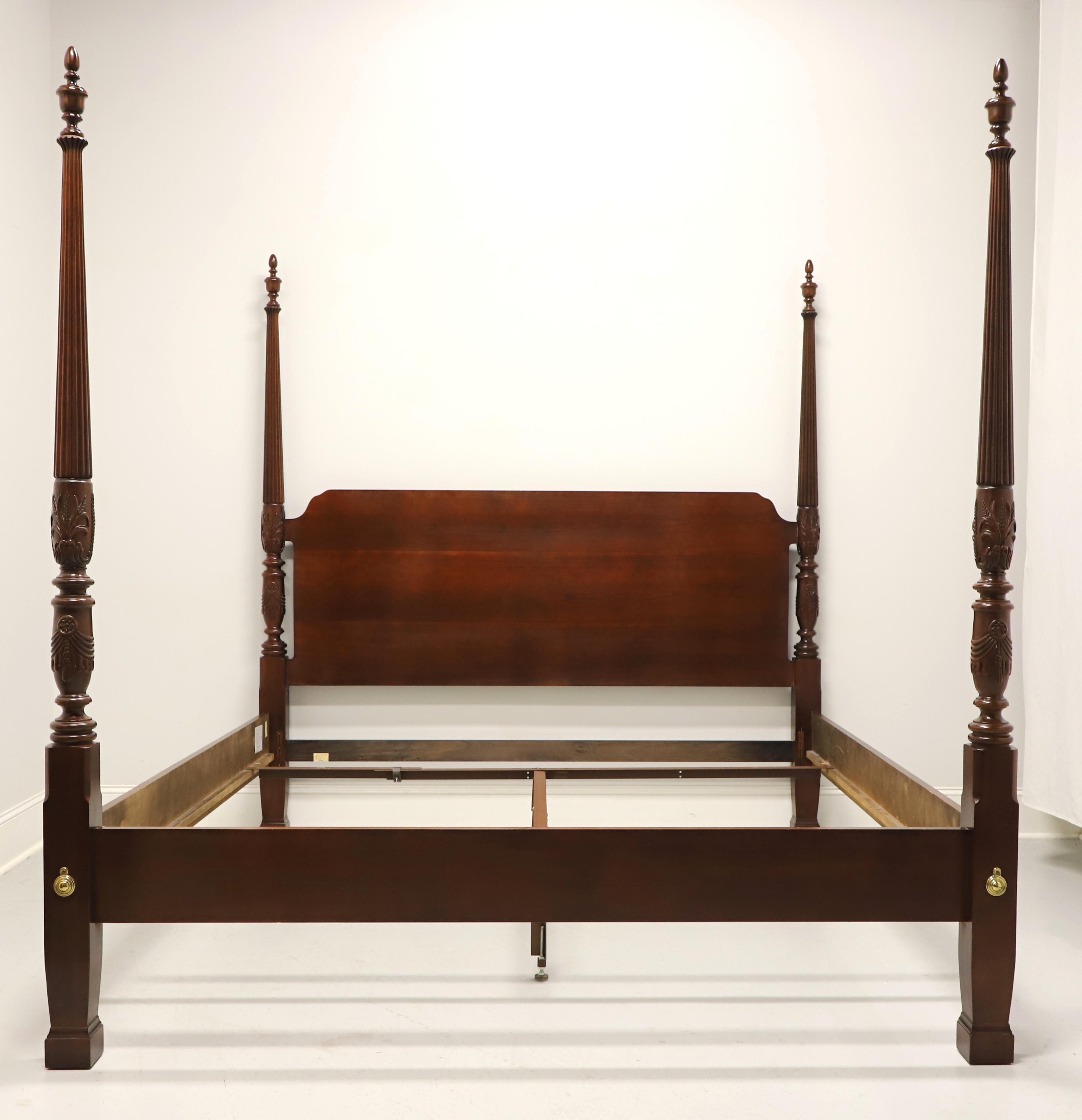 A Chippendale style king Size rice carved poster bed by Thomasville, from their Collectors Cherry Collection. Cherry wood with carved arch headboard, four rice carved posts capped by large finials, clip held side rails with wooden mattress supports,