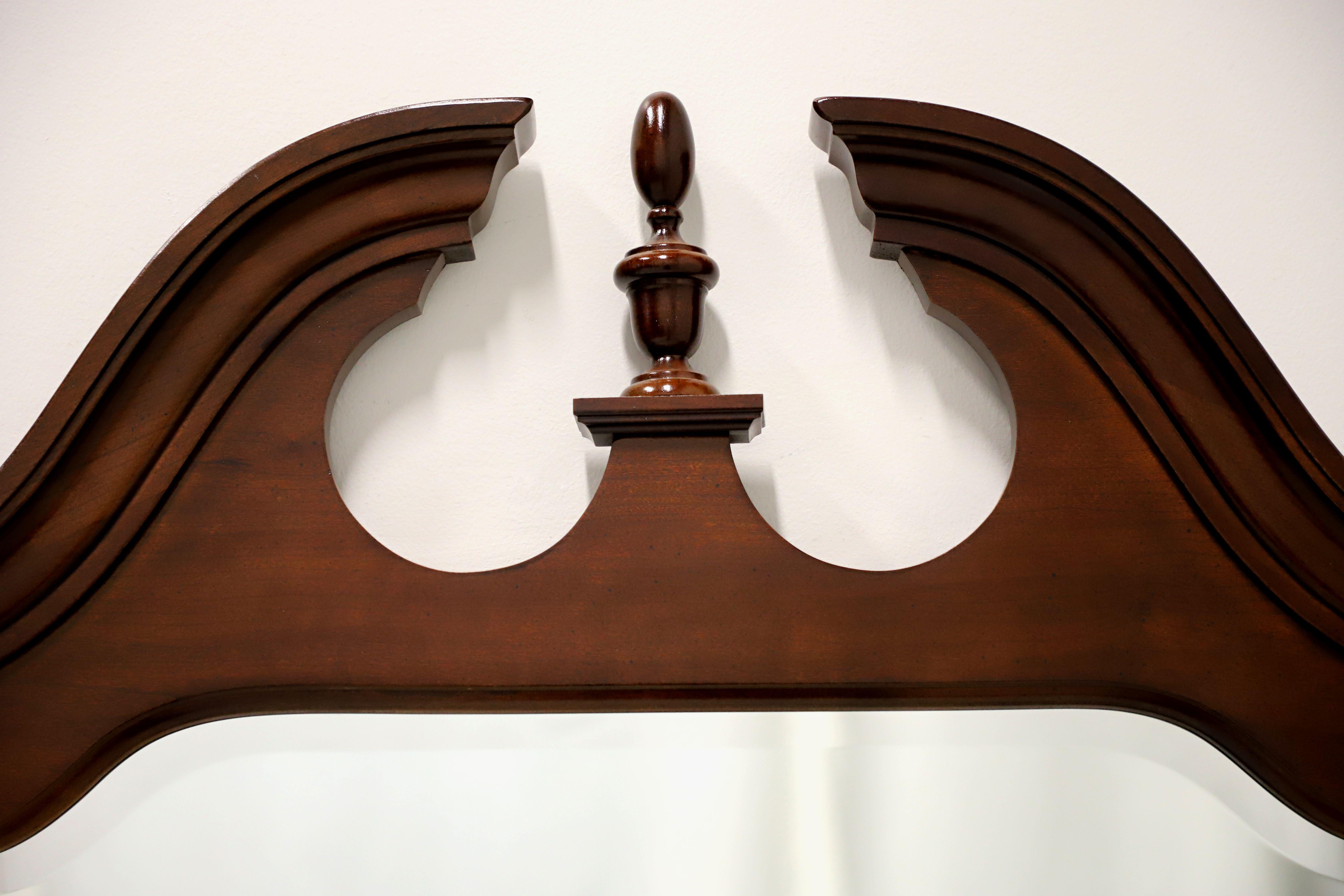 A tri-fold dresser mirror in the Chippendale style by Thomasville, from their Collectors Cherry Collection. Cherry wood frame and bevel edge to mirror glass. Features a pediment with a finial to top of the center mirror and two side mirrors with