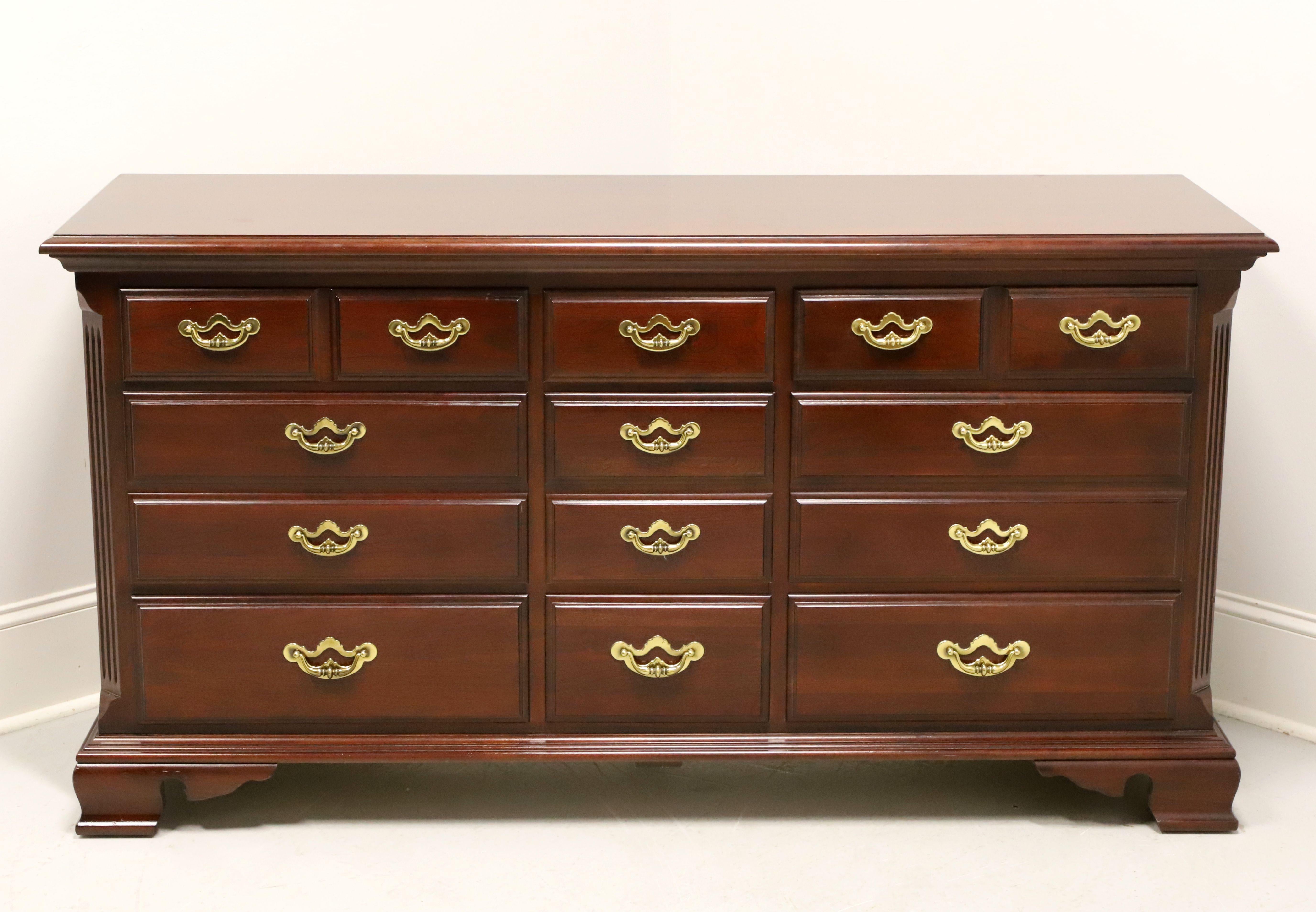 A Chippendale style triple dresser by Thomasville, from their Collectors Cherry Collection. Cherry wood with brass hardware, bevel edge to the top, and ogee bracket feet. Features nice various size drawers of dovetail construction. Made in North