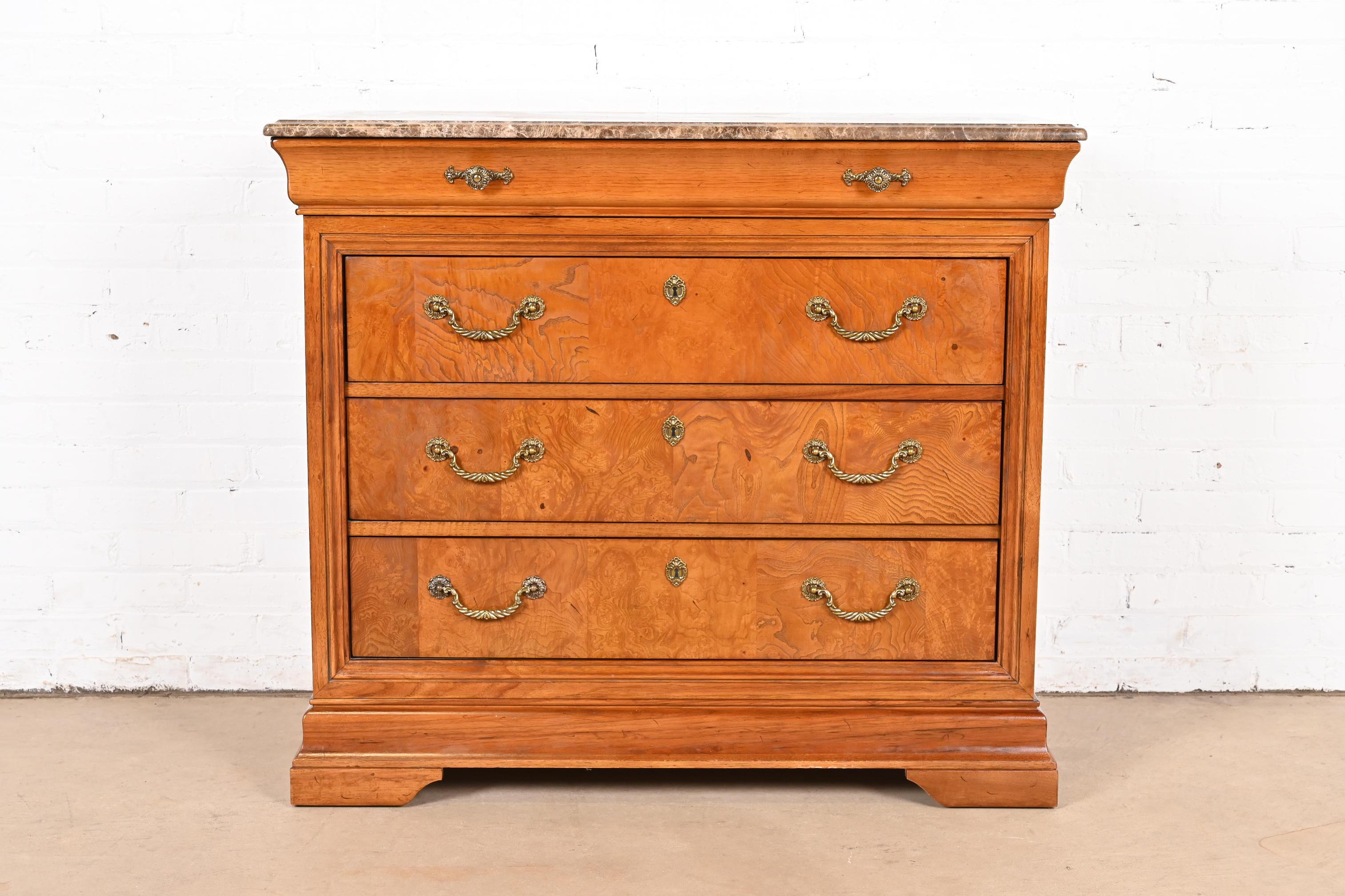 A beautiful French Empire or Louis Philippe style four-drawer dresser or chest of drawers

By Thomasville

USA, Late 20th Century

Gorgeous burl wood, with thick beveled marble top, and original brass hardware.

Measures: 41.63