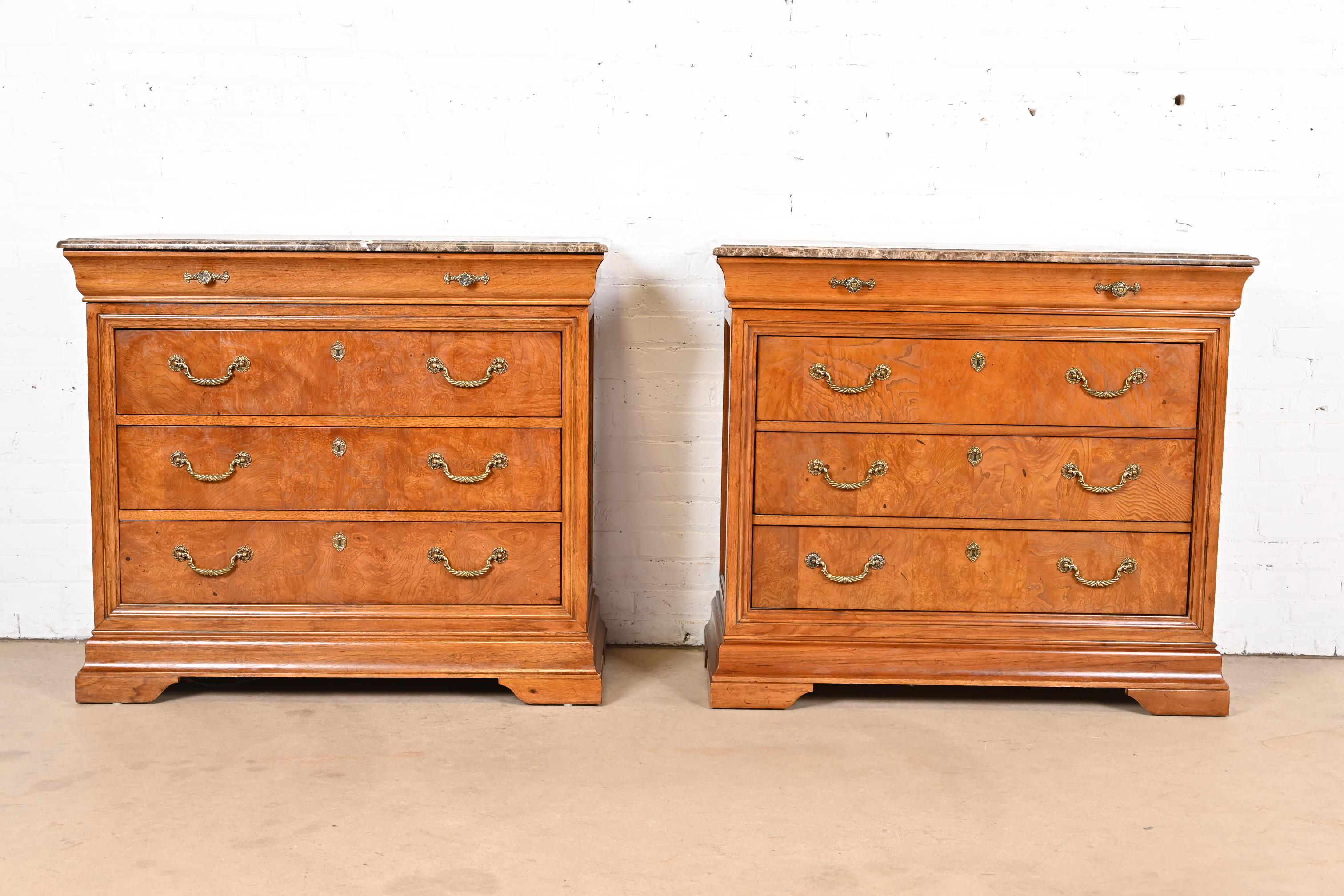 A beautiful pair of French Empire or Louis Philippe style four-drawer dressers or chests of drawers

By Thomasville

USA, Late 20th Century

Gorgeous burl wood, with thick beveled marble tops, and original brass hardware.

Each measures: 41.63