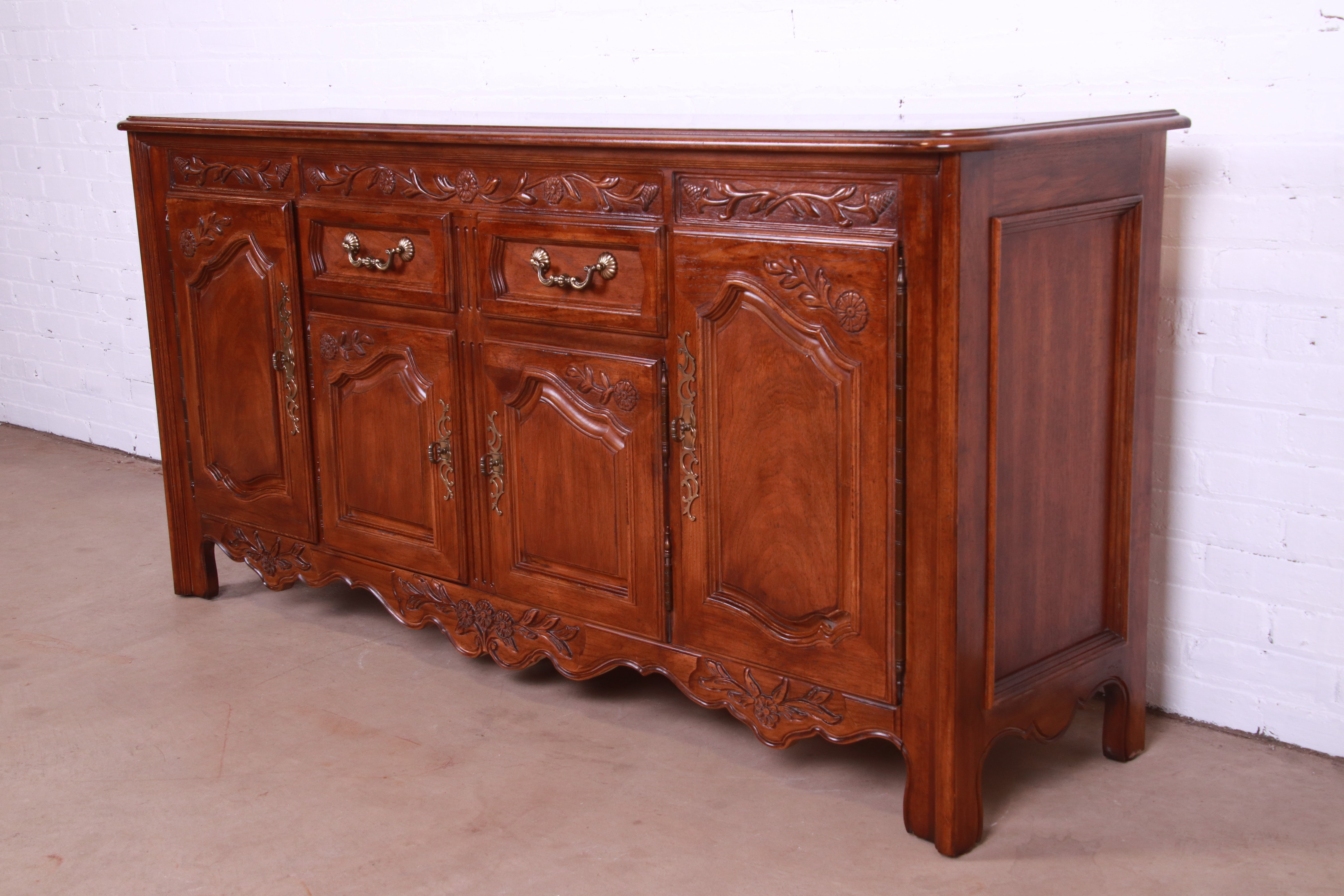 A gorgeous French Provincial Louis XV style sideboard, credenza, or bar cabinet

By Thomasville

USA, Circa 1980s

Carved walnut, with original brass hardware.

Measures: 71