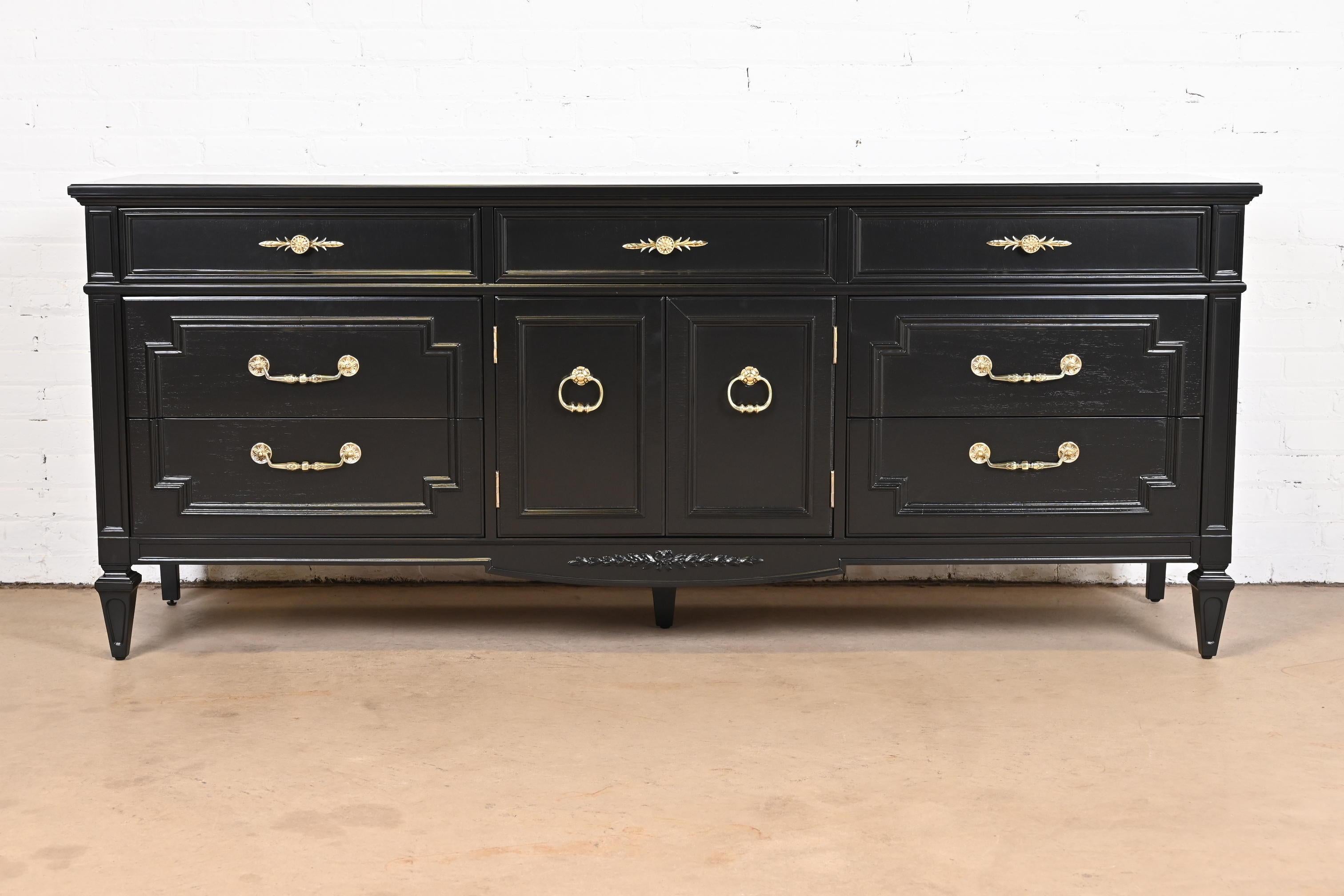 A gorgeous French Regency Louis XVI style dresser or credenza

by Thomasville

USA, circa 1960s

Black lacquered carved walnut, with original brass hardware.

Measures: 77.5