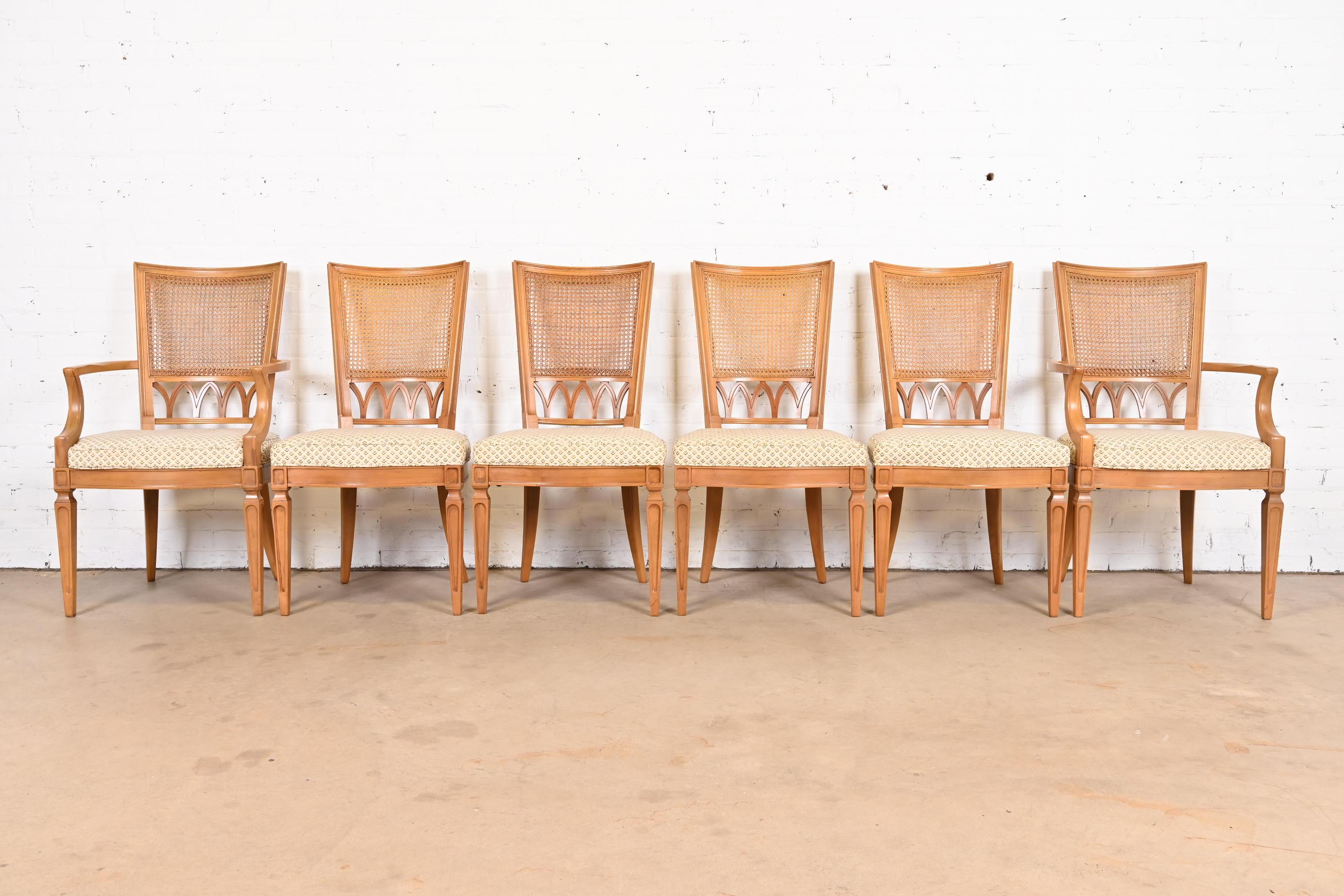 A gorgeous set of six French Regency Louis XVI style dining chairs

By Thomasville

USA, 1960s

Carved solid fruitwood, with caned backs and upholstered seats.

Measures:
Side chairs - 21