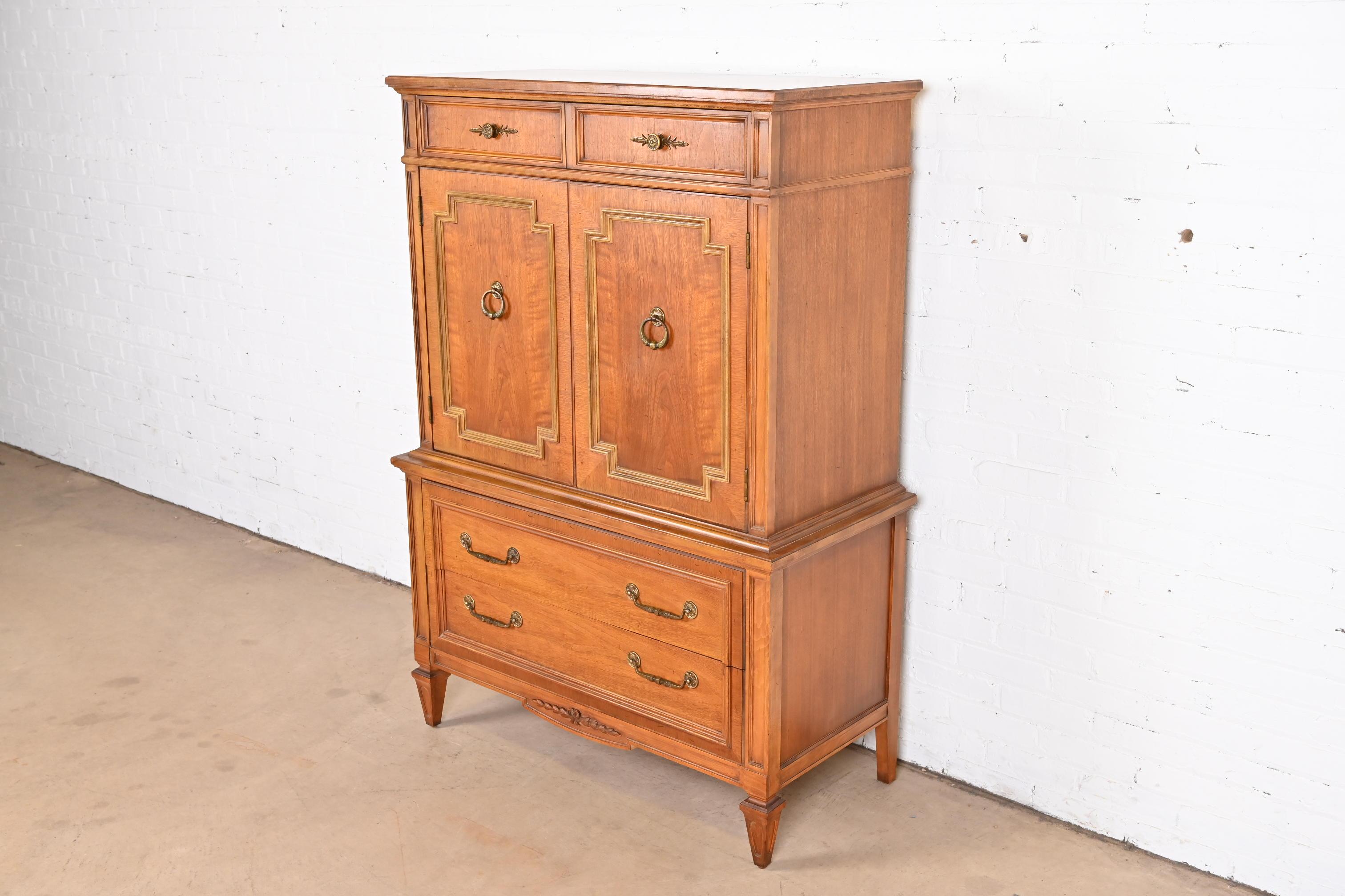 A gorgeous midcentury French Regency Louis XVI gentleman's chest or highboy dresser

By Thomasville

USA, 1950s

Carved walnut, with original brass hardware.

Measures: 42