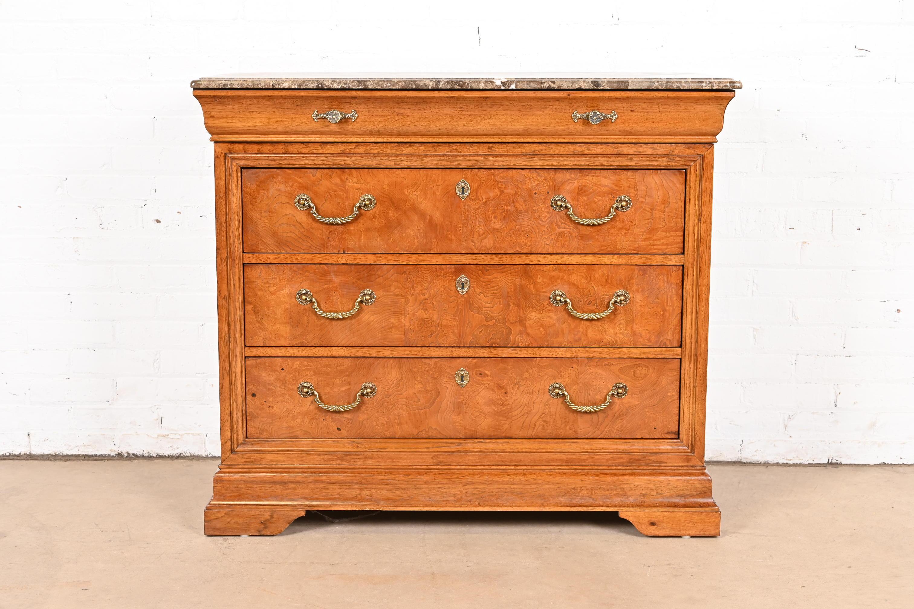 A beautiful French Empire or Louis Philippe style four-drawer dresser or chest of drawers

By Thomasville

USA, Late 20th Century

Gorgeous burl wood, with thick beveled marble top, and original brass hardware.

Measures: 41.63