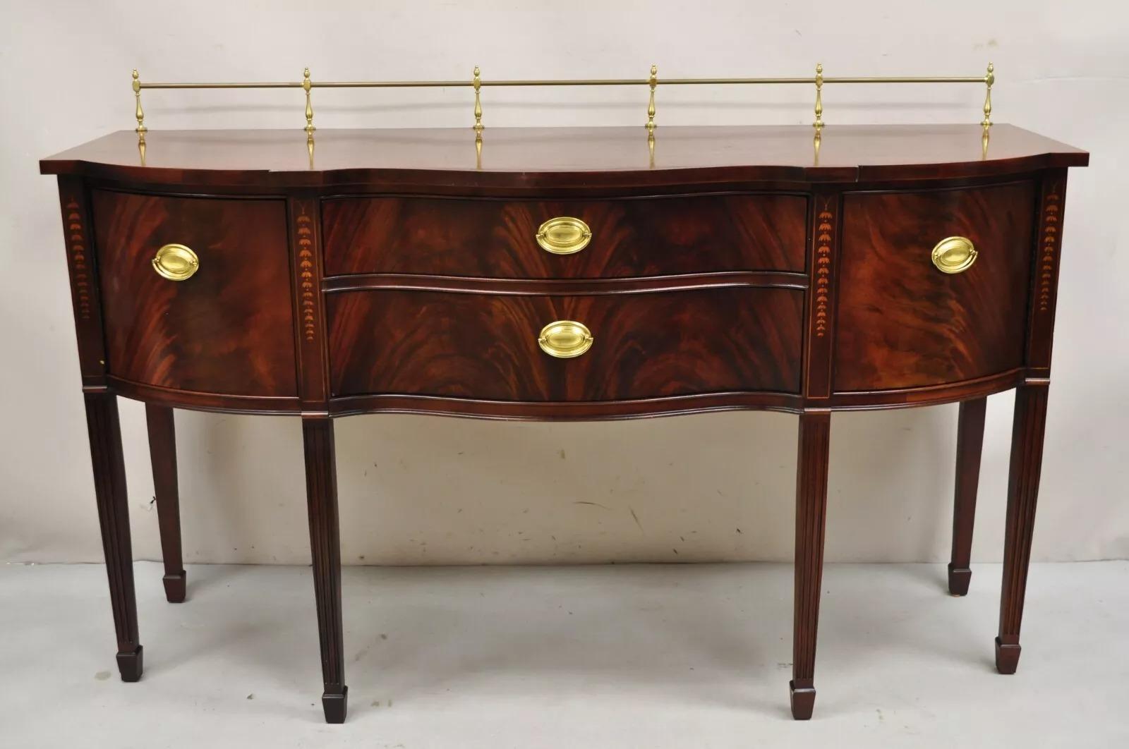 Thomasville Hepplewhite Federal Style Inlaid Mahogany Sideboard Buffet with Brass Gallery. Item features 2 dovetailed drawers, bell flower inlay, 2 swing doors, brass gallery, original stamp, quality American craftsmanship. Circa Late 20th Century.