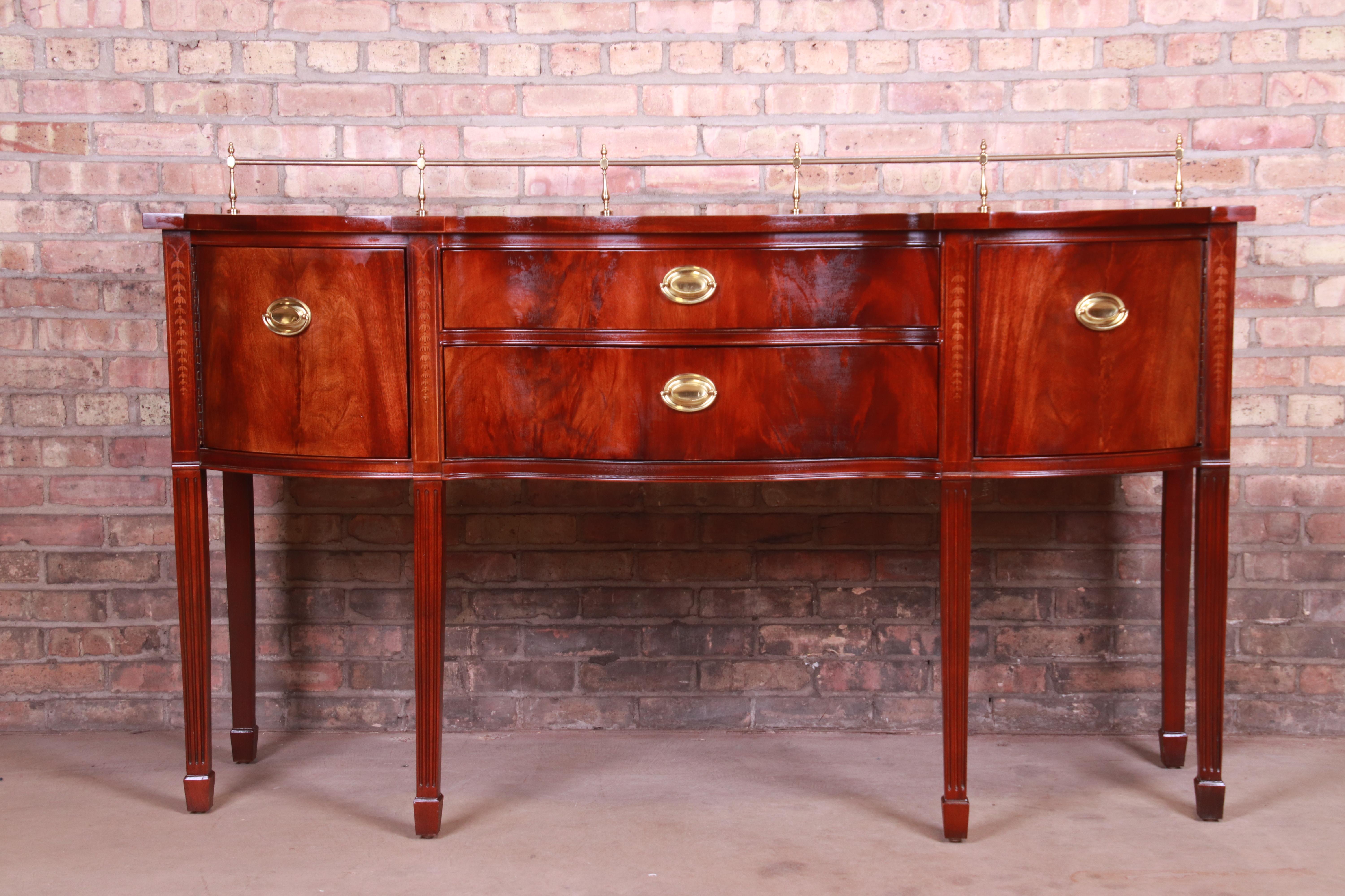 A gorgeous Hepplewhite style sideboard buffet or credenza

By Thomasville

USA, circa 1980s

Book-matched flame mahogany, with inlaid satinwood and original brass hardware and gallery.

Measures: 66