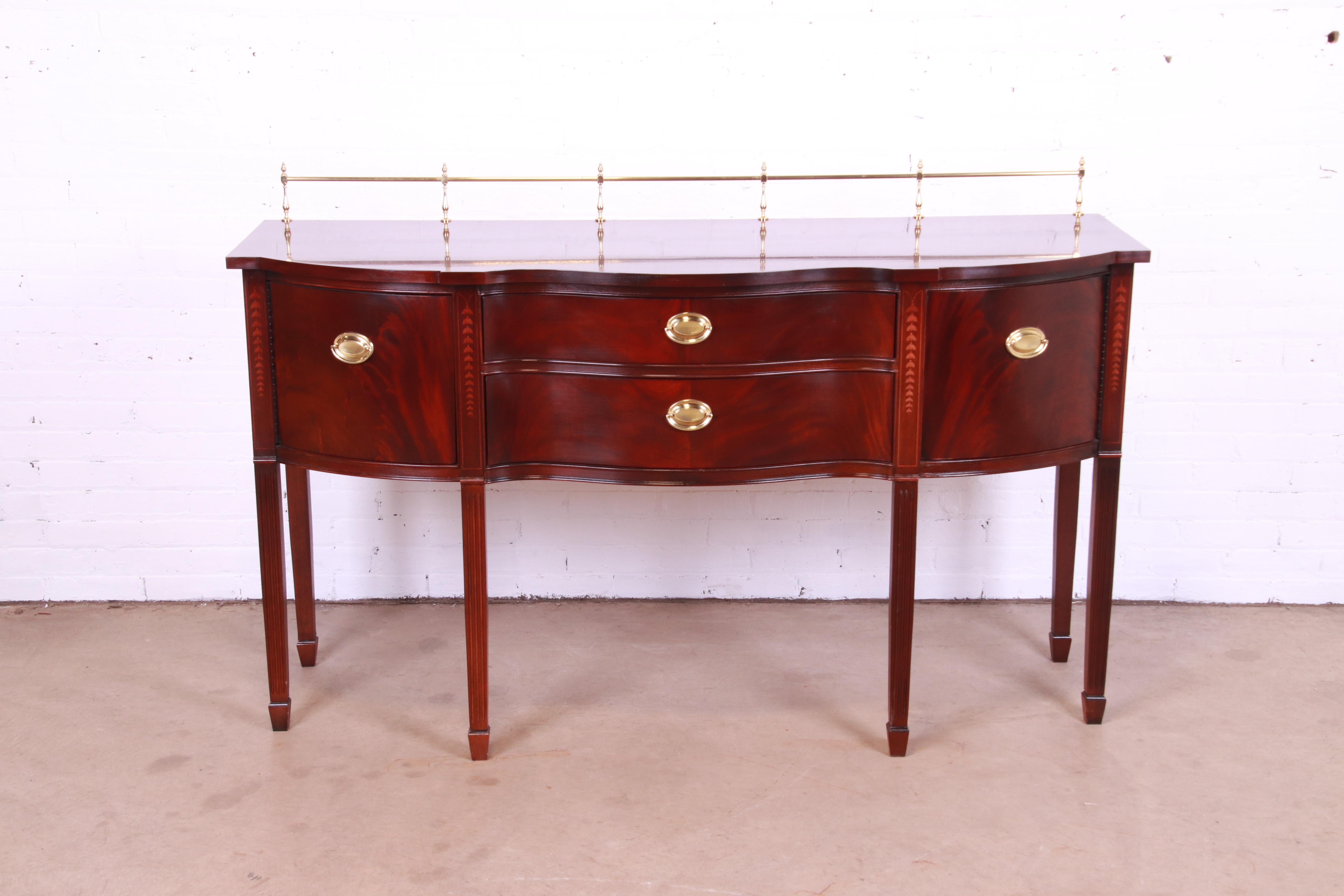 A gorgeous Hepplewhite or Federal style serpentine front sideboard, buffet, or credenza

By Thomasville

USA, Circa 1980s

Mahogany, with inlaid satinwood marquetry and original brass hardware and gallery.

Measures: 66