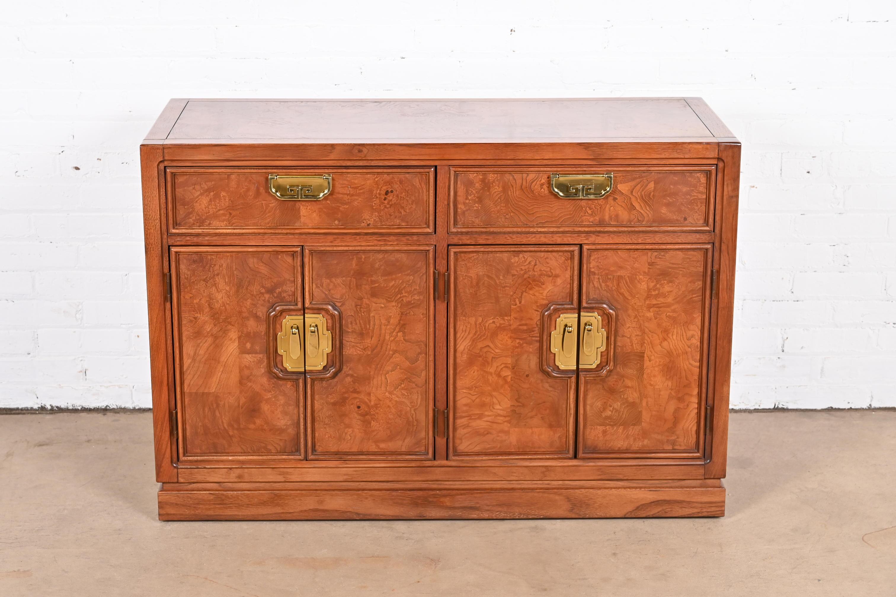 A stunning Mid-Century Modern Hollywood Regency Chinoiserie sideboard, credenza, or bar cabinet

By Thomasville

USA, Circa 1970s

Gorgeous figural burl wood and walnut, with original Asian-inspired brass hardware.

Measures: 44