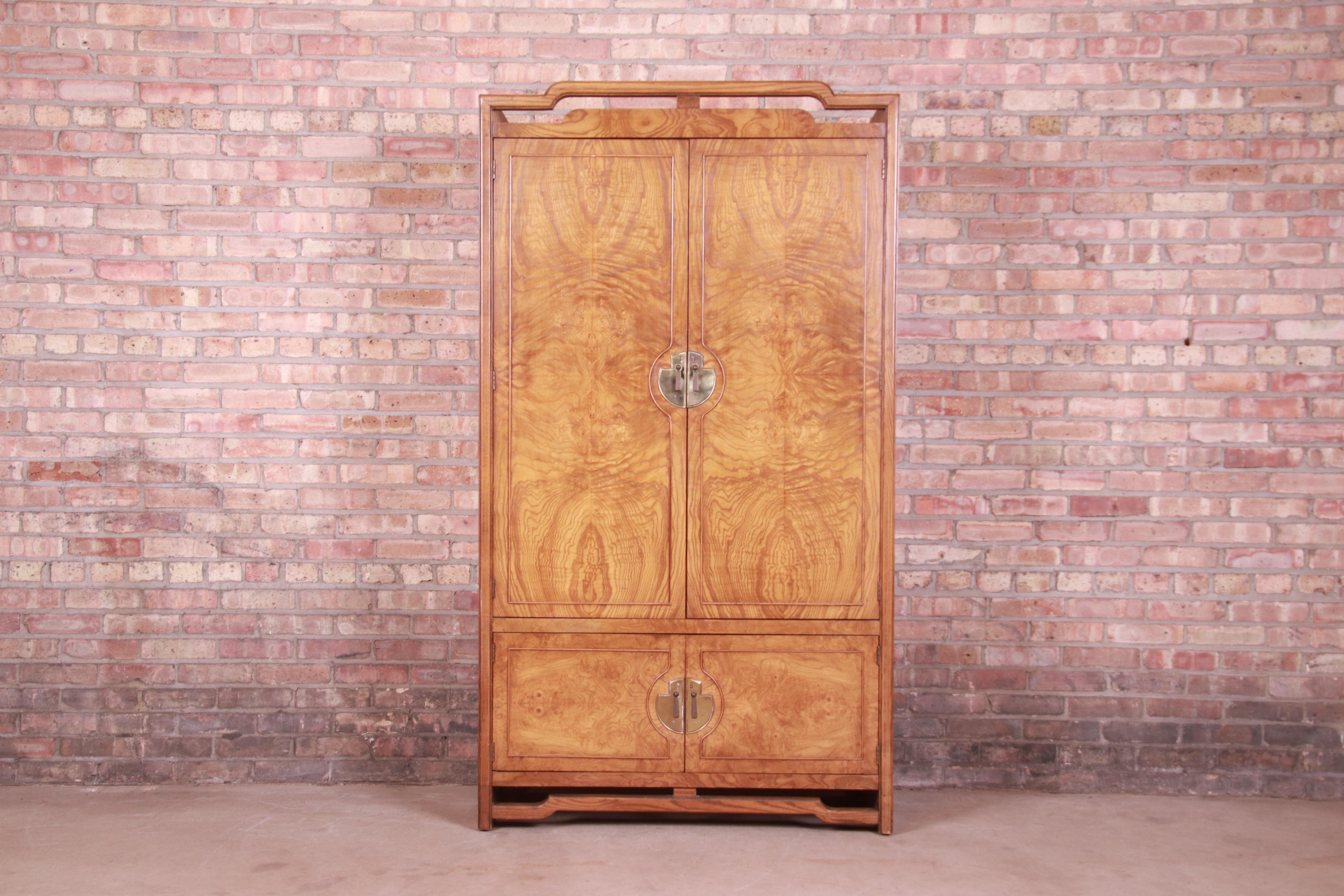 An exceptional Mid-Century Modern Hollywood Regency Chinoiserie gentleman's chest or armoire dresser

By Thomasville

USA, 1970s

Burled olive wood, with original Asian-inspired brass hardware.

Measures: 40