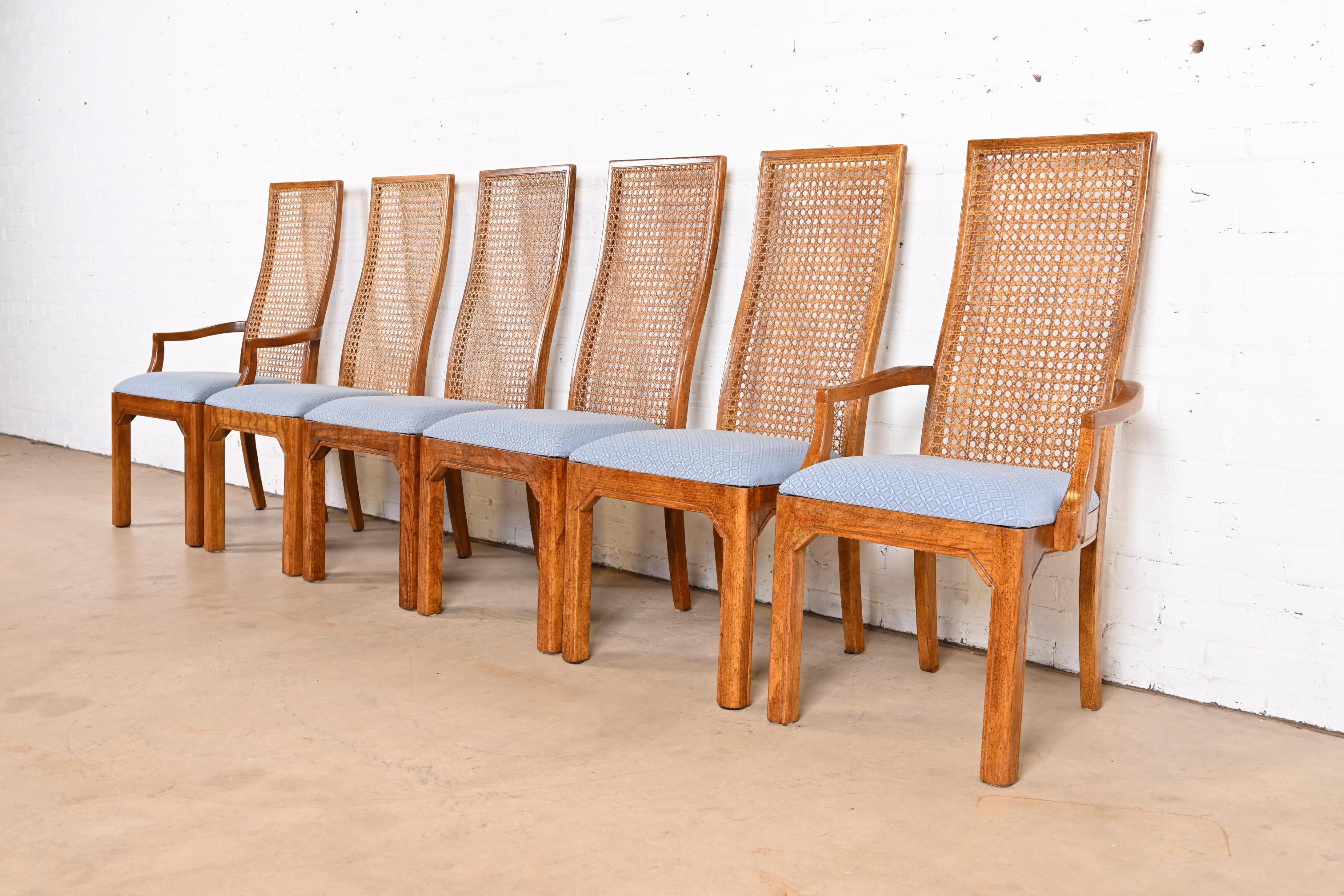 A gorgeous set of six Mid-Century Modern high back dining chairs

By Thomasville

USA, Circa 1970s

Oak frames, with cane backs and upholstered seats.

Measures:
Side chairs: 19