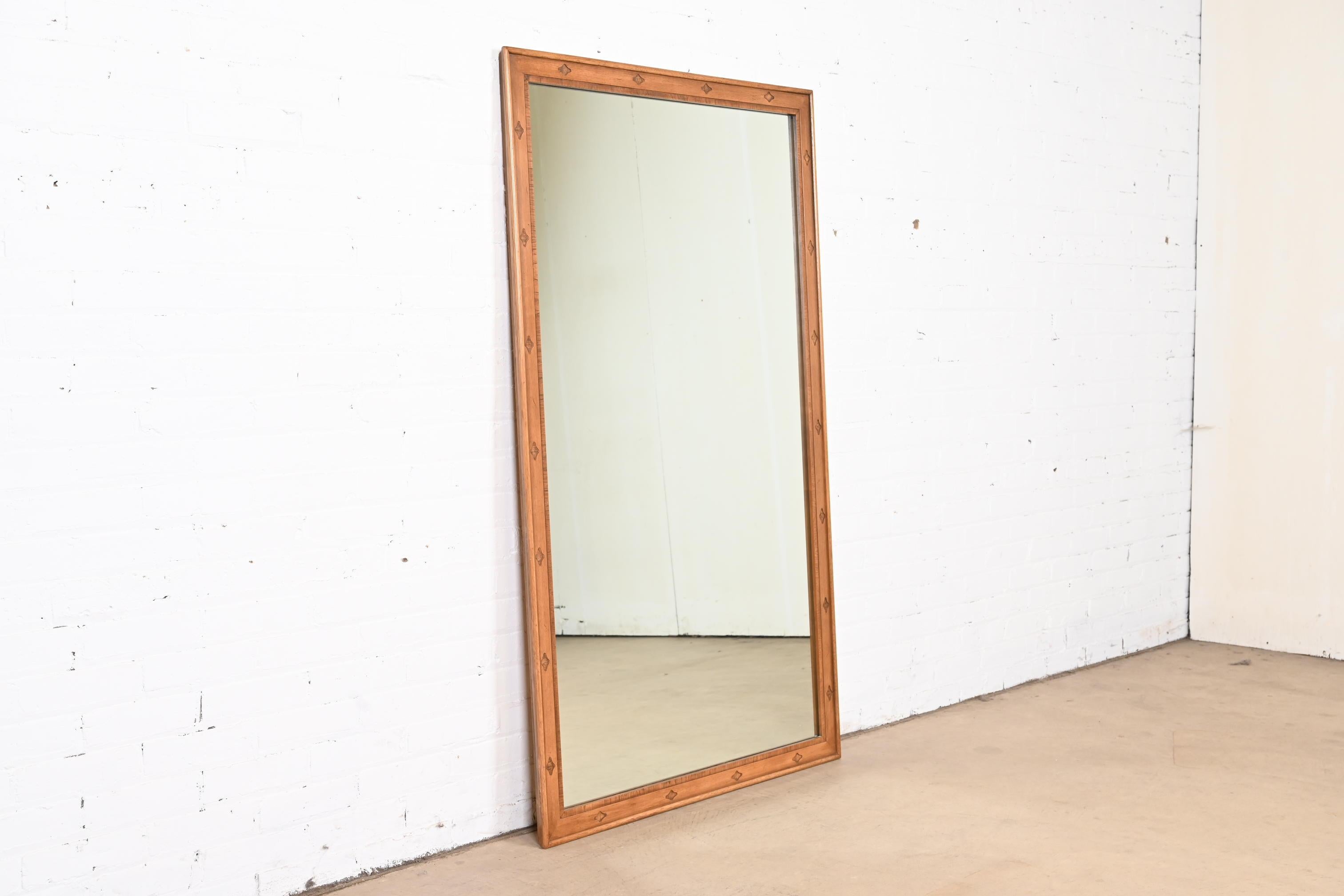 A stylish Mid-Century Modern sculpted walnut framed wall mirror

By Thomasville, 