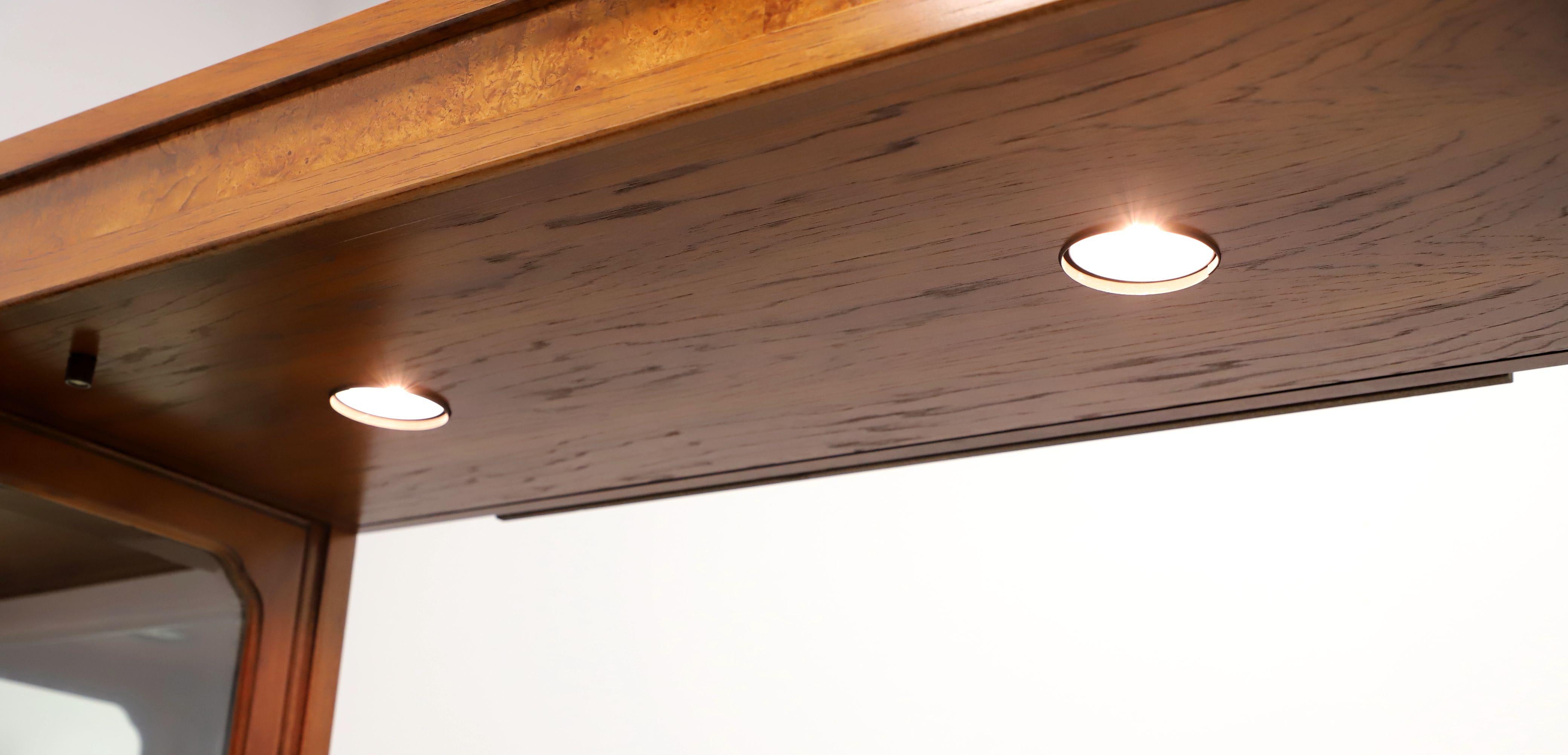 An Asian inspired 44 inch light bridge, ideal for over a console cabinet, by Thomasville, from their Mystique Collection. Walnut with inlaid burl walnut, metal support brackets, and two light fixtures with push button switch. Wired for standard