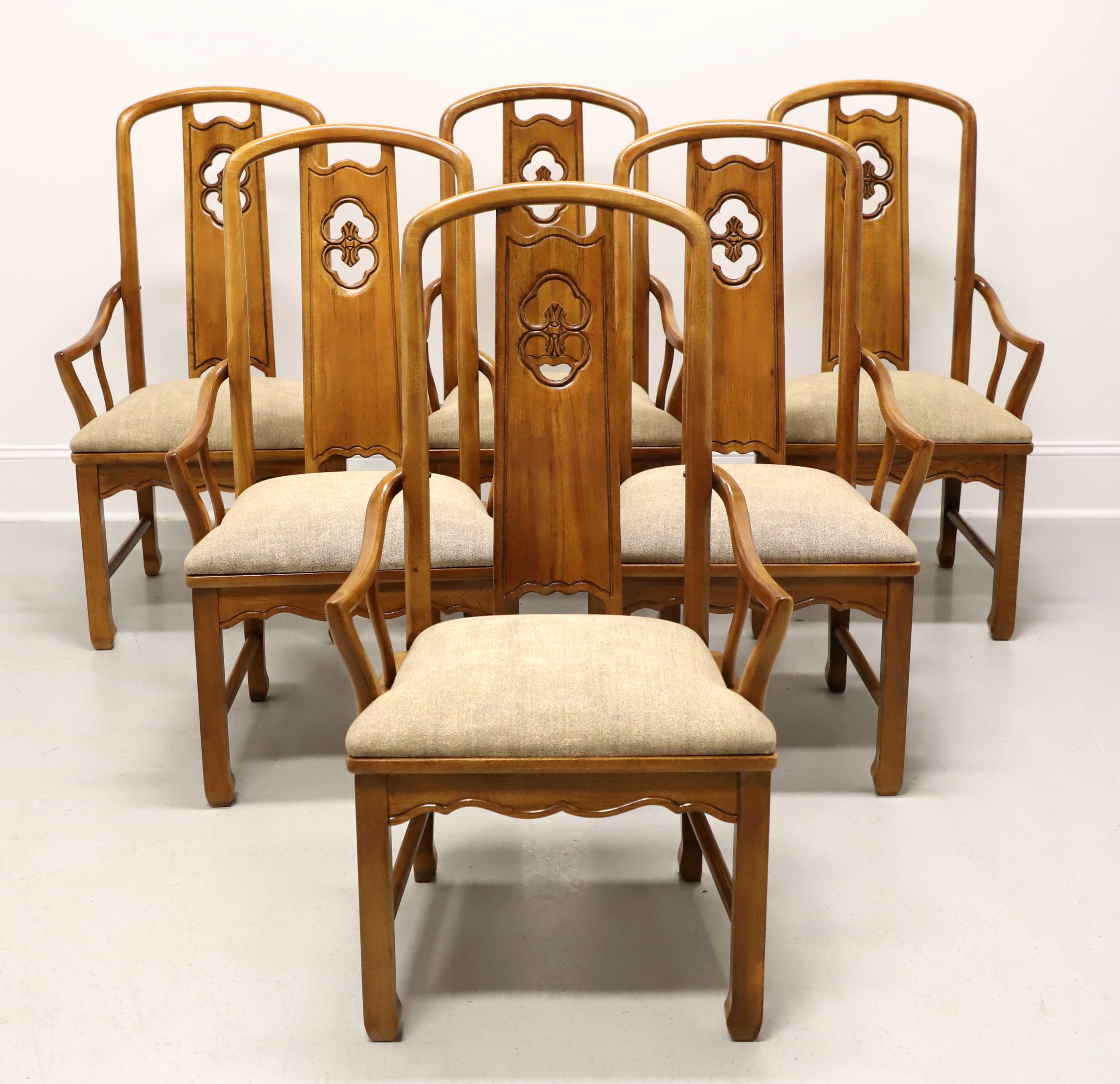 A set of six Asian inspired dining armchairs by Thomasville, from their Mystique Collection. Walnut with carved center backs, rounded curved arms with supports, upholstered seats in a shimmery bronze color fabric, carved apron, straight square legs,