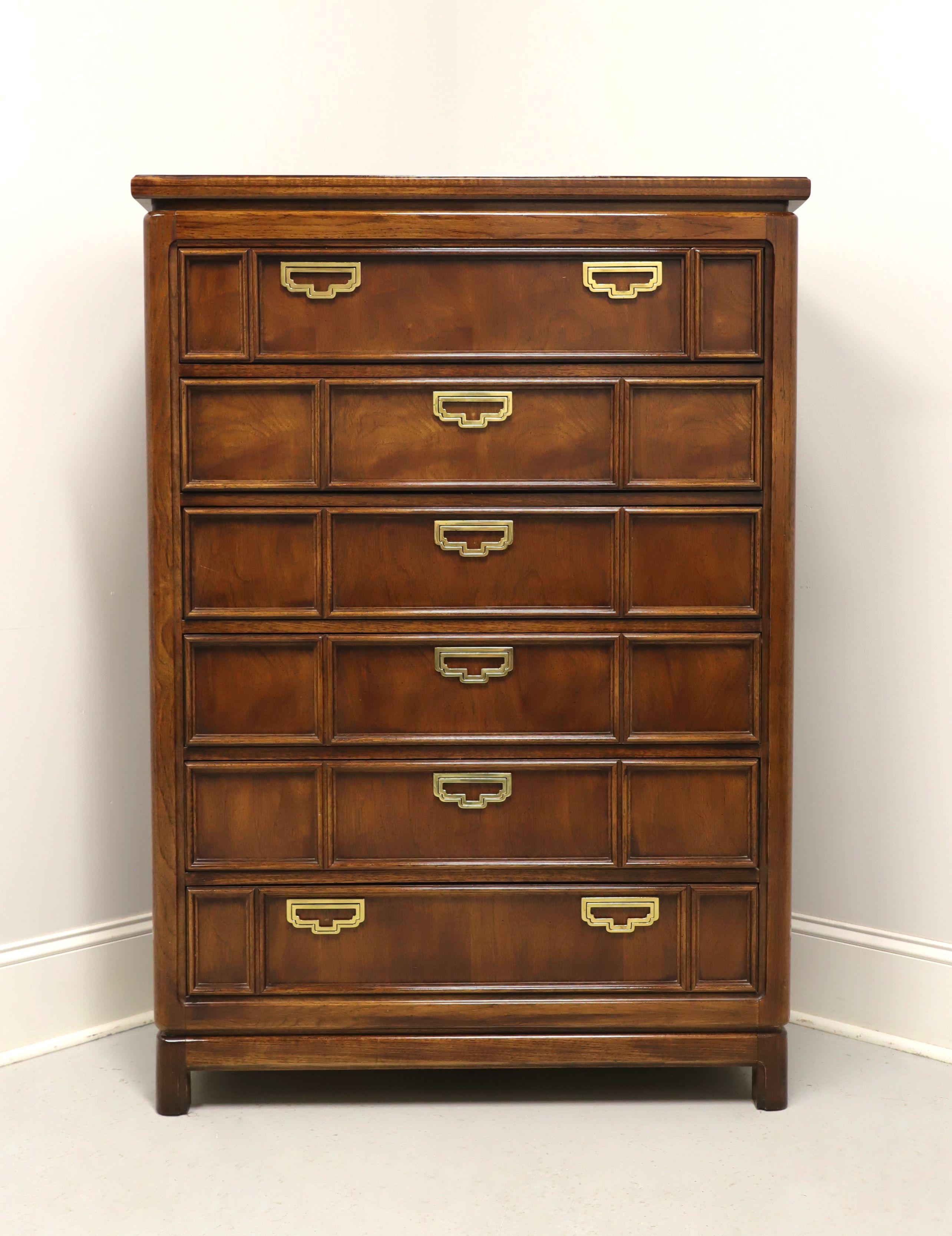 An Asian influenced chest of drawers by Thomasville, from their Mystique II Collection. Oak with a banded parquetry inlaid top, brass hardware, distinctive styling to drawer fronts, and rounded feet. Features six drawers of dovetail construction.