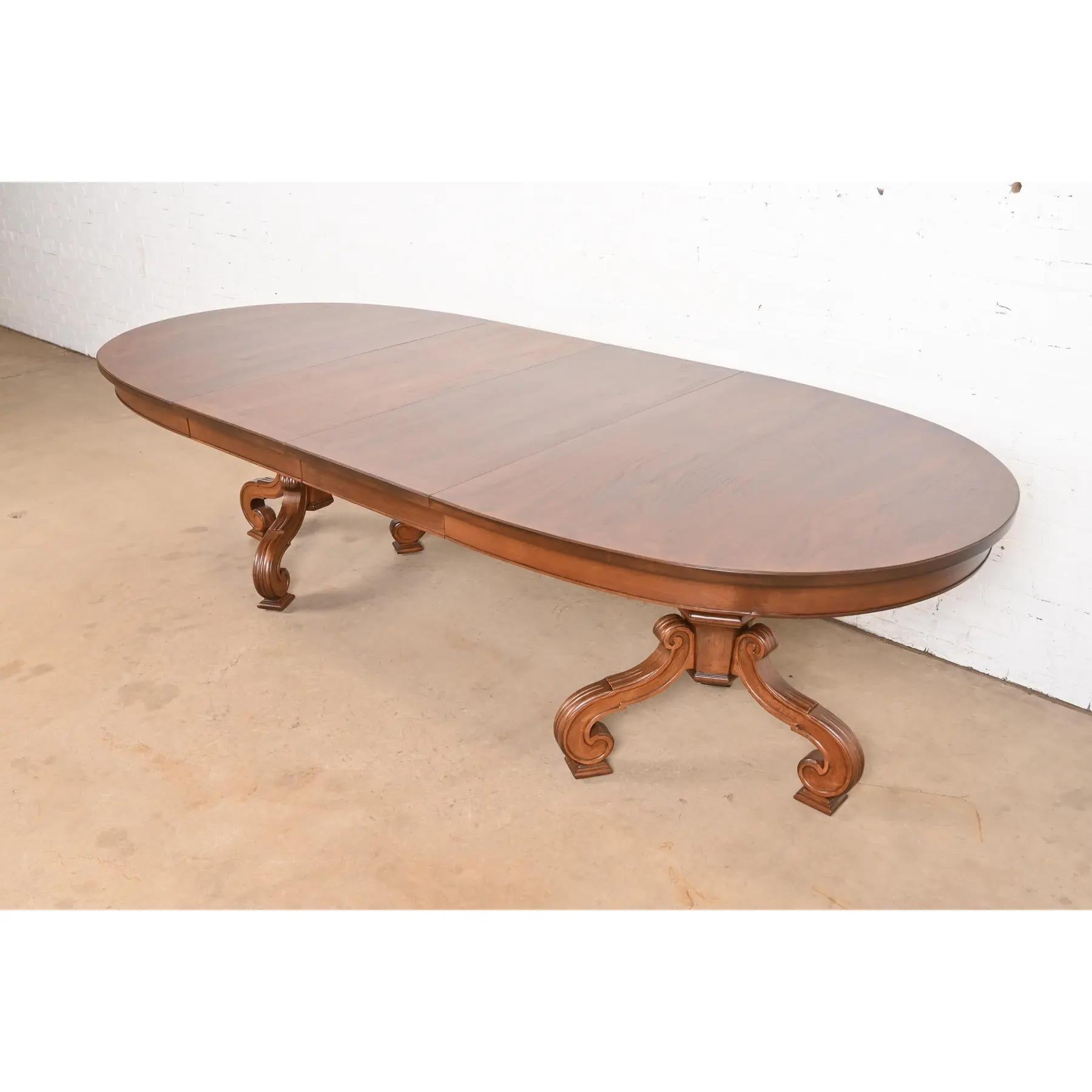 An outstanding Regency, Italian Provincial, or Neoclassical style double pedestal extension dining table

By Thomasville

USA, Circa 1960s

Gorgeous walnut top with burl wood banding, and carved walnut pedestals.

Measures: 68.5