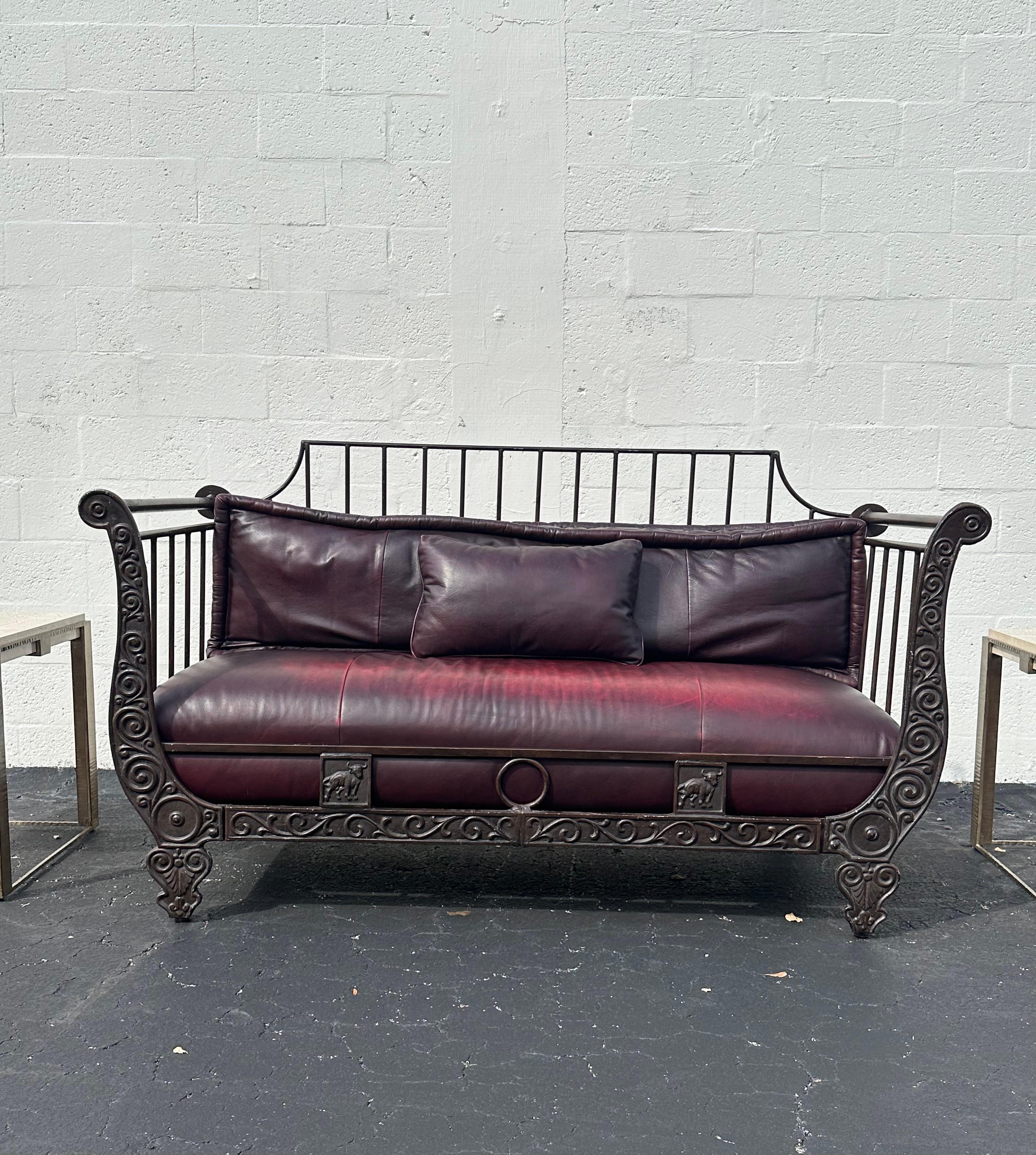 Transport yourself back to the sleek and sophisticated early 2000s with this exquisite sculptural iron and distressed burgundy leather sofa daybed.. The ultra rare daybed exudes an air of luxury and refinement. Outstanding design is exhibited