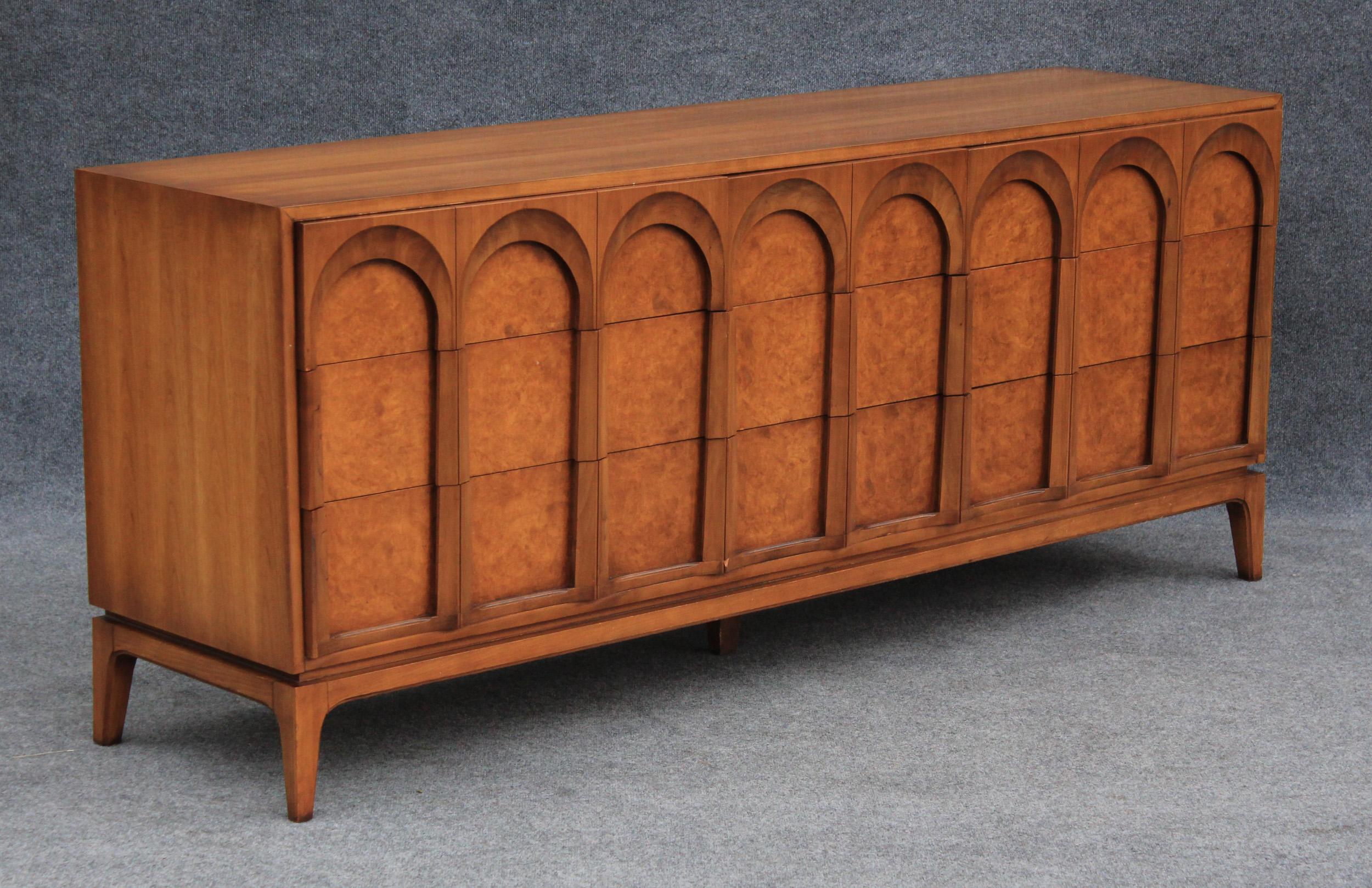 In the classic and timeless style of T.H. Robsjohn Gibbings, the 'Arched' series by Thomasville is made in the US, circa 1960s, and is of heirloom quality. The finest hardwoods of walnut and olive ash burl, create a sculptural rhythm that evokes