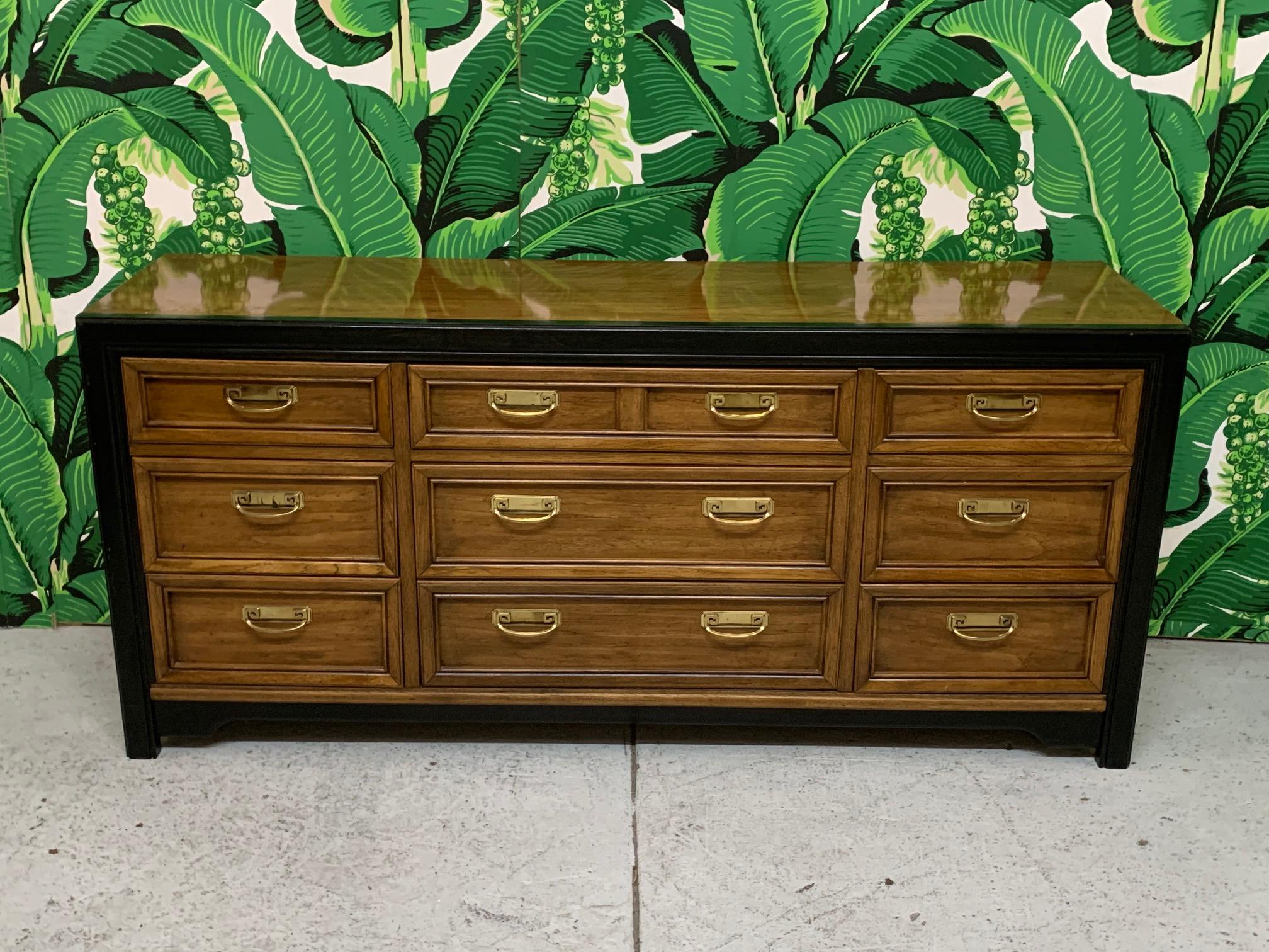Triple dresser by Thomasville features two-tone finish and brass hardware. Very good condition with minor imperfections consistent with age.