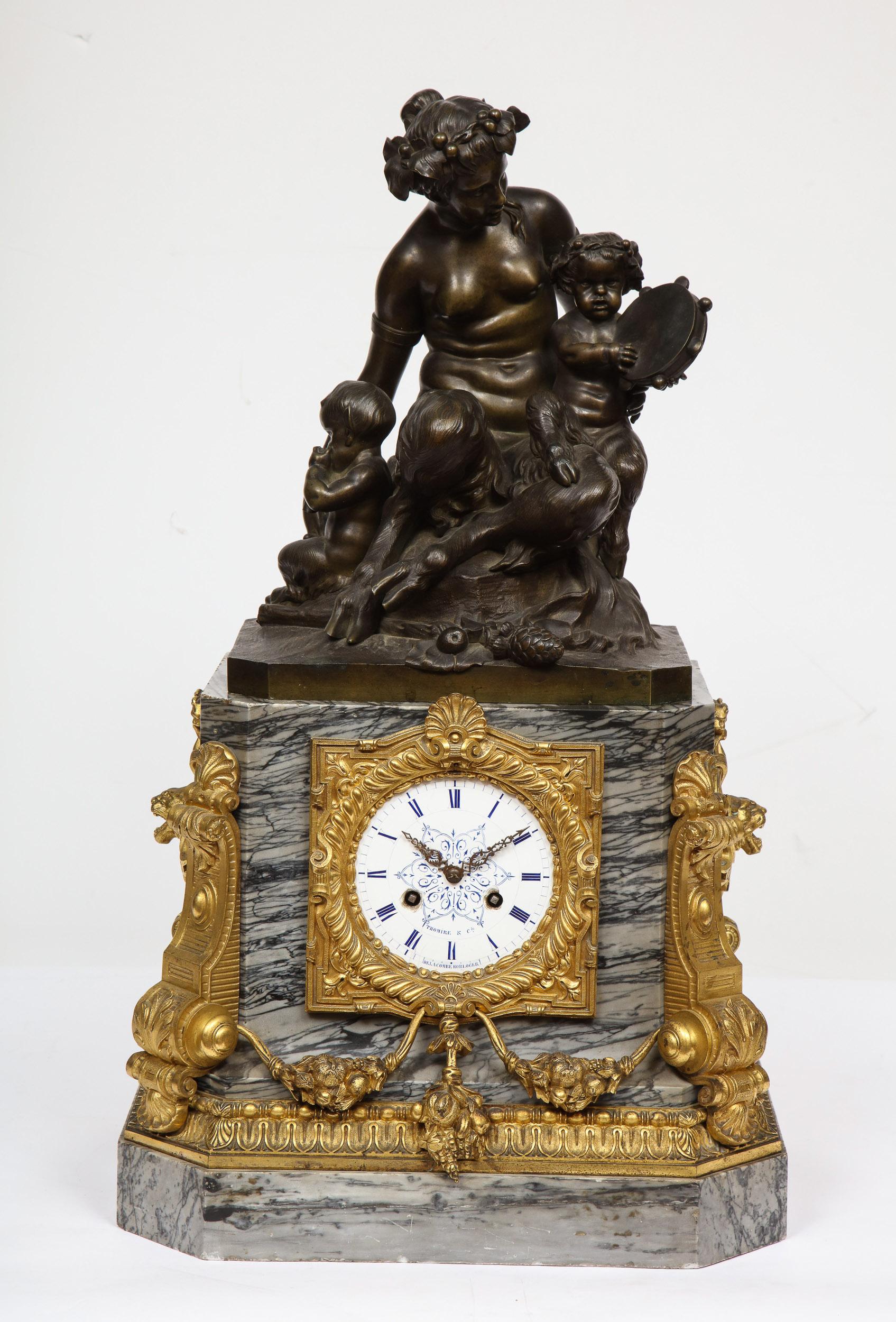 Thomire & Cie, A French gilt and patinated bronze and marble figural mantel clock,
circa 1850.

The clock case in gray marble, surmounted by a patinated bronze sculpture of female satyr accompanied by young fawns playing music, the case centered