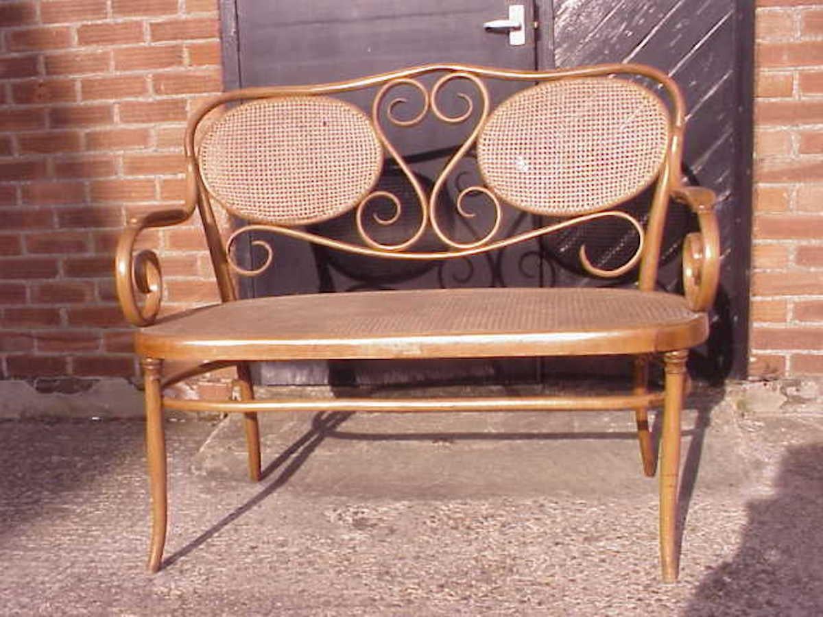 Vienna Secession Thonet, A Bentwood Settee with Scrollwork Decoration with a Caned Seat & Back For Sale