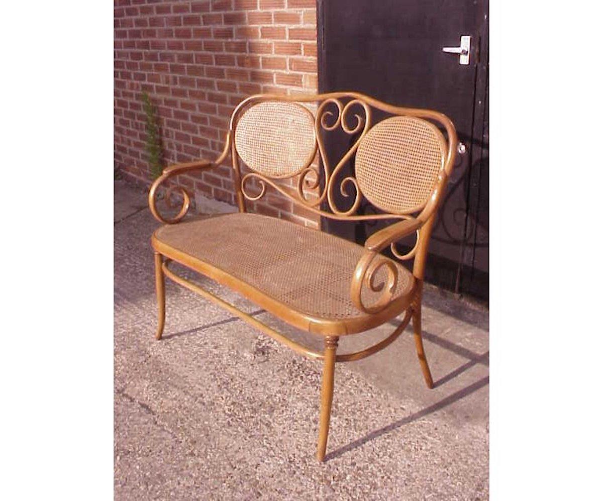 Hand-Crafted Thonet, A Bentwood Settee with Scrollwork Decoration with a Caned Seat & Back For Sale
