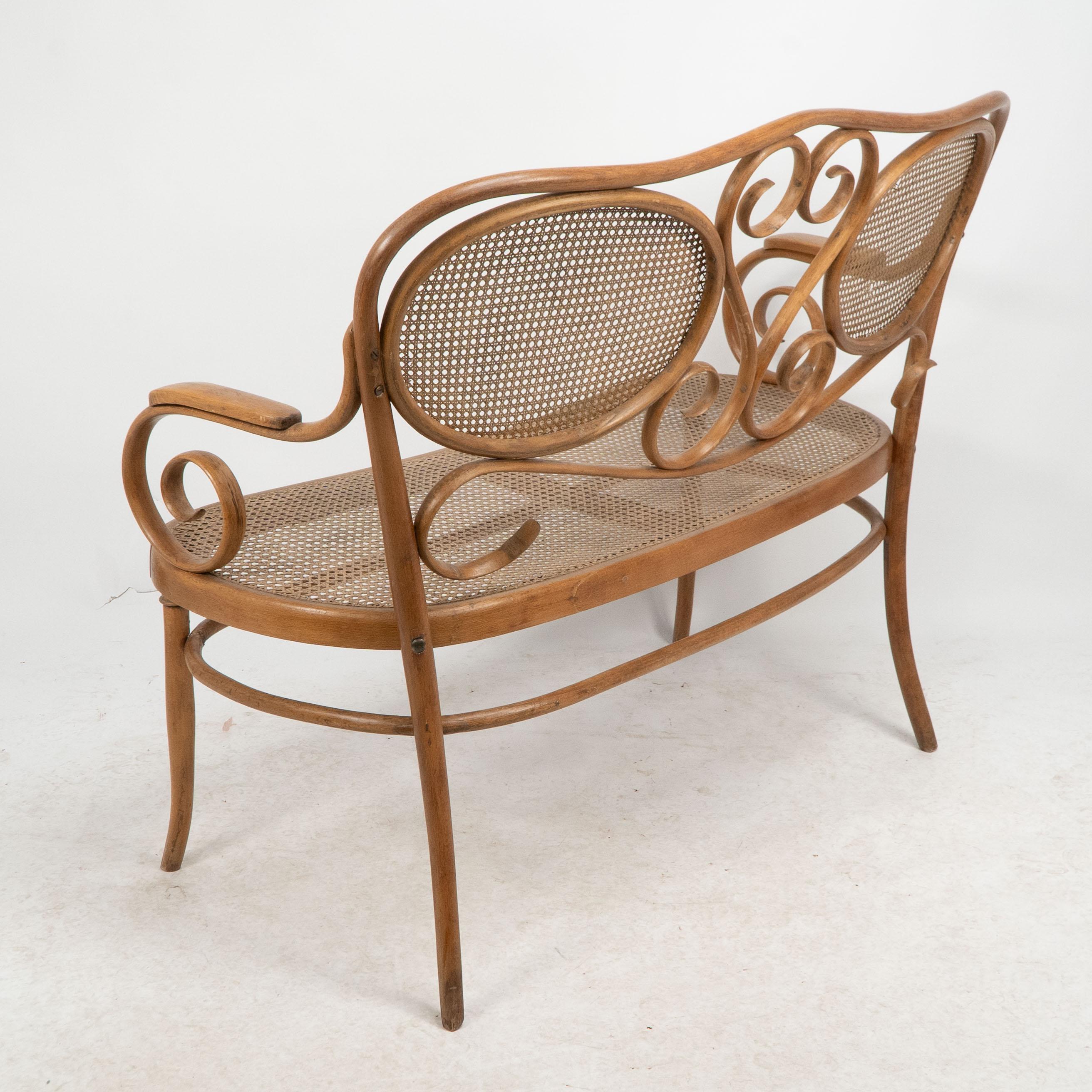 Thonet. A bentwood settee with scrollwork decoration with caned seat & back For Sale 8